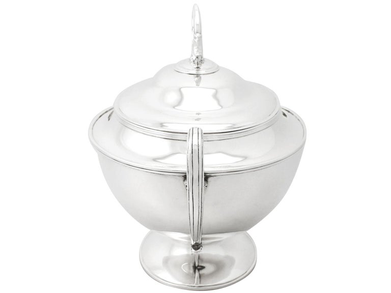 A fine and impressive antique Edwardian English sterling silver soup tureen; an addition to our silver dining collection

This fine antique Edwardian sterling silver soup tureen has a plain oval shaped form onto a plain oval domed spreading