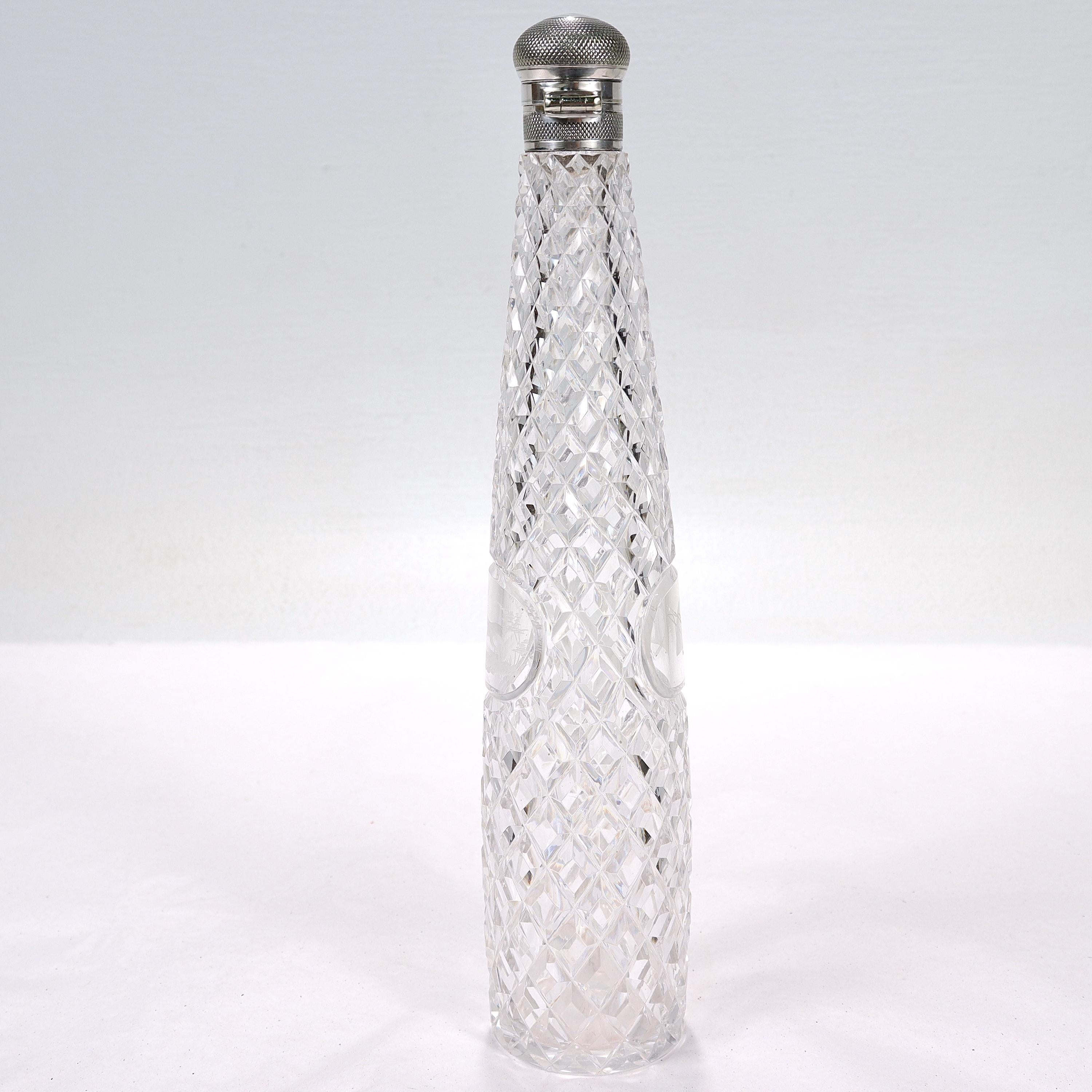 A fine antique silver-topped cut glass hunting flask.

With a narrow tapering cut glass body with a diamond pattern terminating in a screw-top integral sterling silver lid.

There are 2 small cartouches on either side - one depicts a fox and the