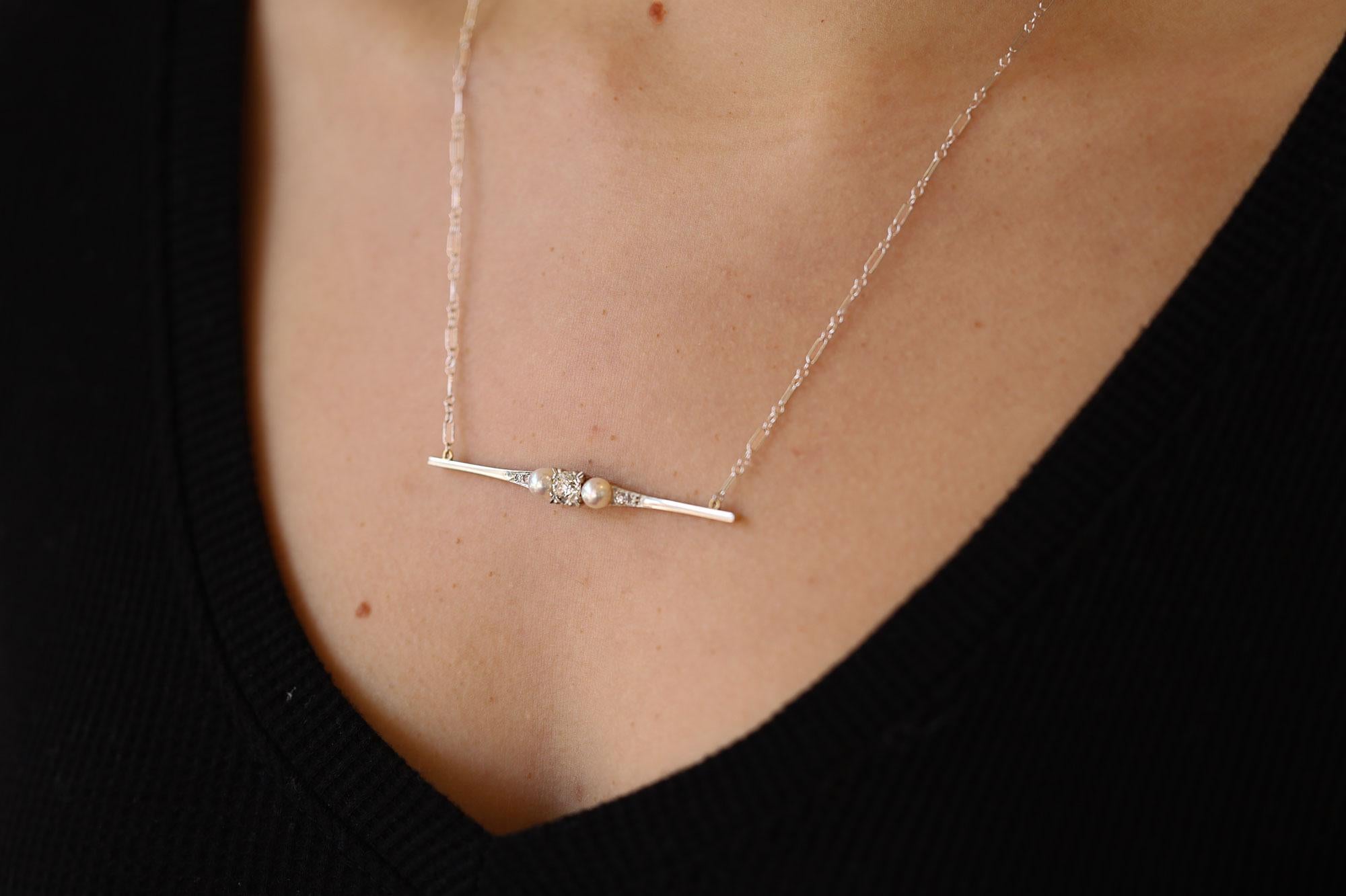 The Piper Ridge pearl and diamond bar necklace is a clever conversion from an antique Edwardian pin. Centered by a sparkling and fiery near 3/4 carat old European cut round diamond flanked by a pair of lustrous cultured pearls terminating with