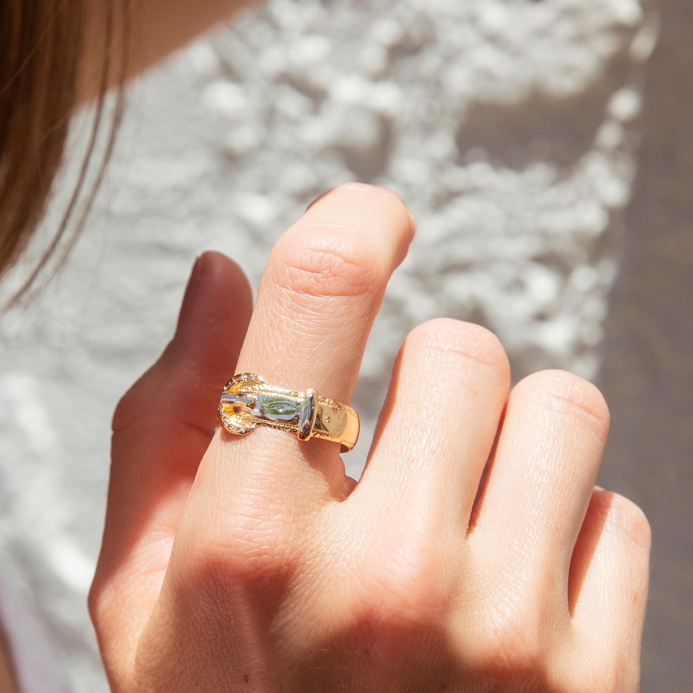 Forged in 18 carat yellow gold, this darling vintage ring features a belt and buckle style design intricately engraved along the front. This whimsical band has been named The Brittany Ring. She is a lovely accompaniment for other beloved fine gems