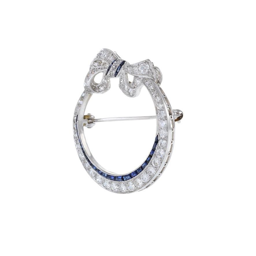 Antique Edwardian Era Platinum Sapphire and Diamond Circle Bow Lapel Pin In Excellent Condition For Sale In New York, NY