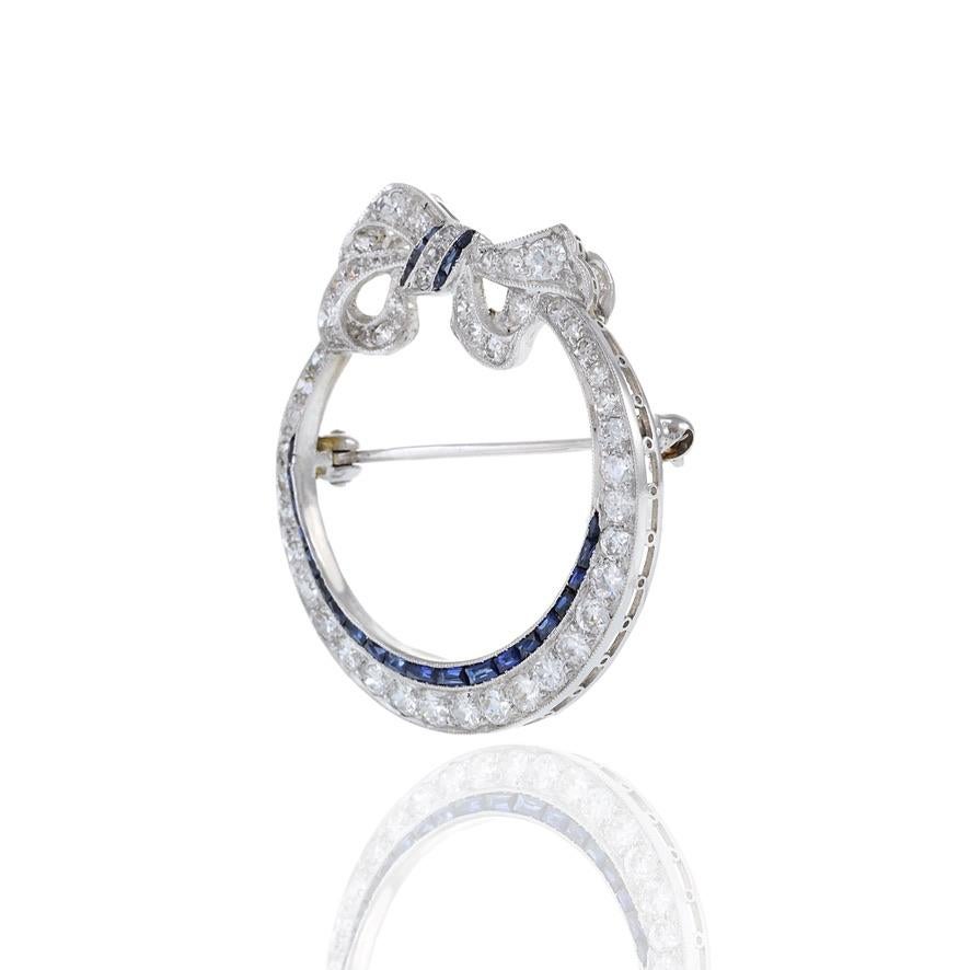 Women's Antique Edwardian Era Platinum Sapphire and Diamond Circle Bow Lapel Pin For Sale