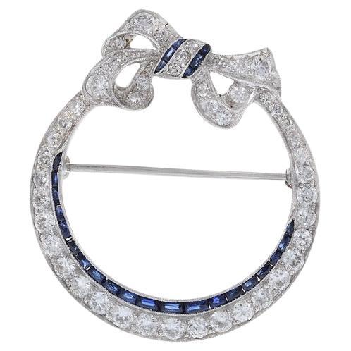 Antique Edwardian Era Platinum Sapphire and Diamond Circle Bow Lapel Pin