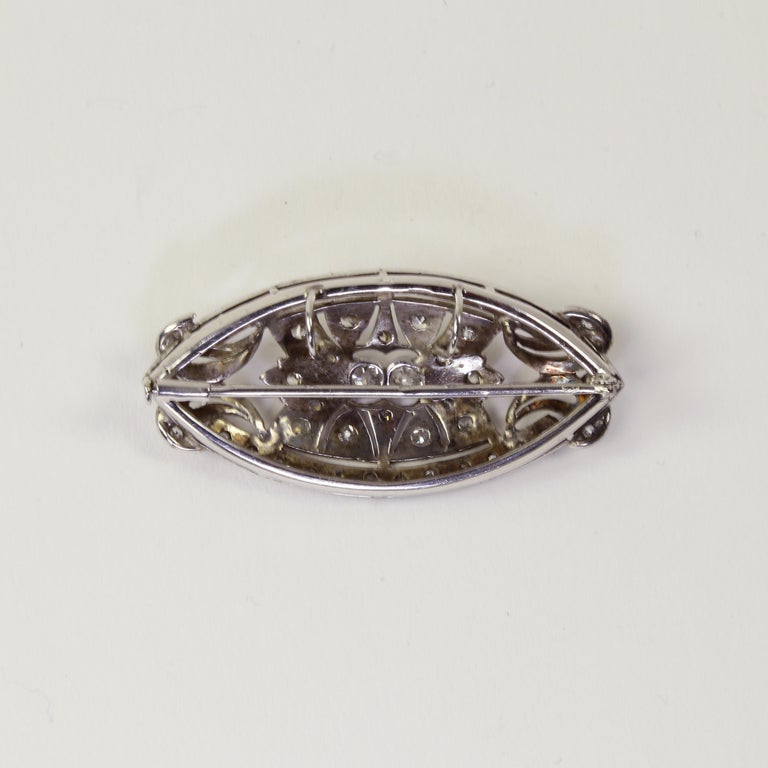 Beautifully hand crafted platinum Diamond Brooch combines classic Edwardian style with the symmetry of Art Deco. Set with approx. 58 Old European cut diamonds. So versatile and well made…can be worn as a pin or pendant. Measures approximately 2