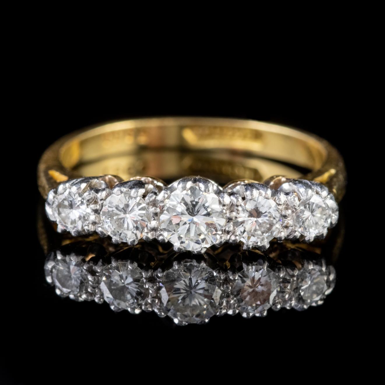 A stunning Antique Edwardian ring lined with five sparkling round brilliant cut Diamonds claw set in a Platinum mount which is fitted to an 18ct Yellow Gold shank. 

Diamonds are a stone of perfection. Their exceptional lustre and brilliant fire