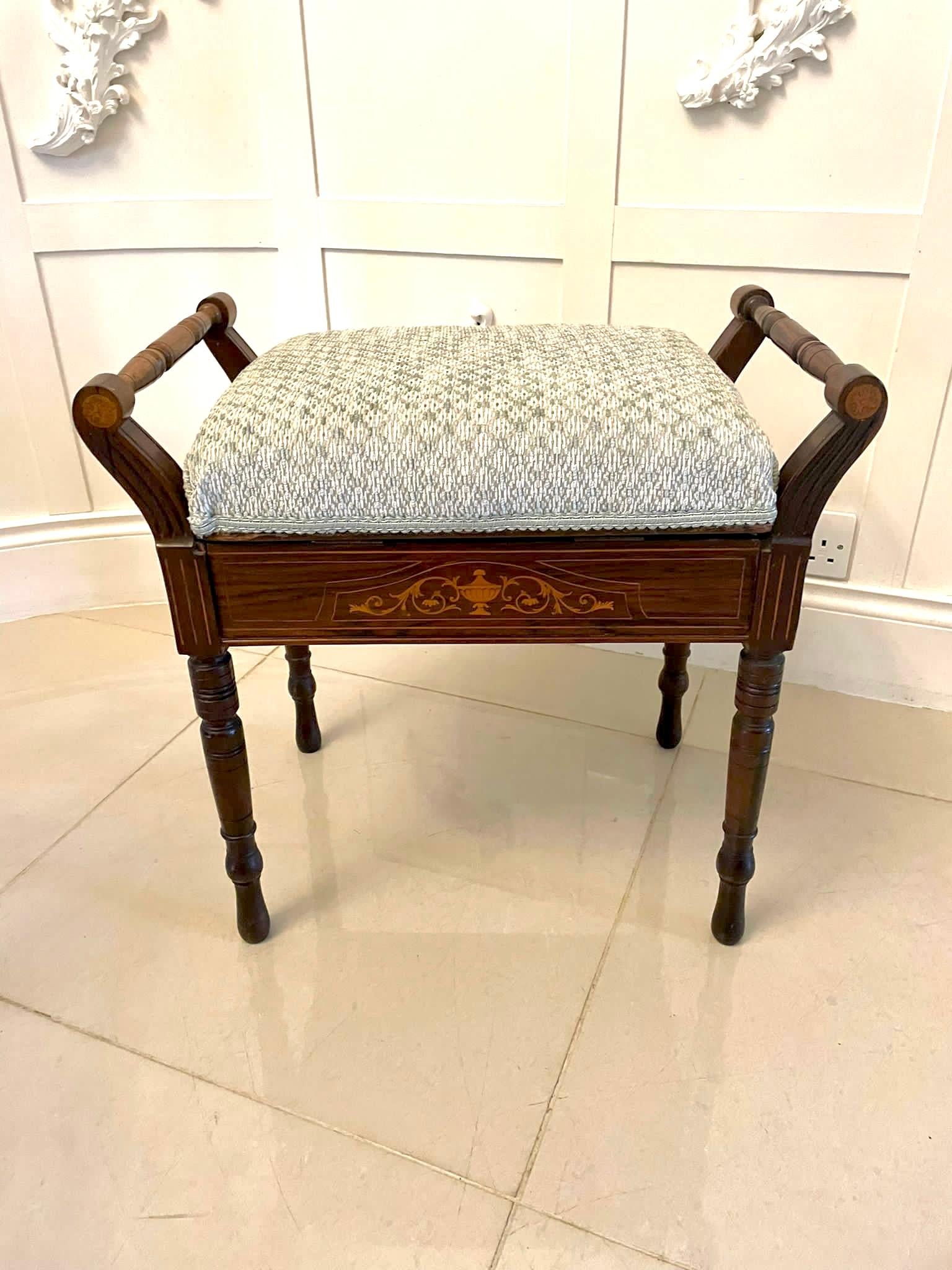 Antique Edwardian freestanding quality rosewood inlaid piano stool having a newly reupholstered lift up seat in a quality fabric above a freestanding quality inlaid rosewood frieze, two turned carrying handles supported by pretty shaped inlaid