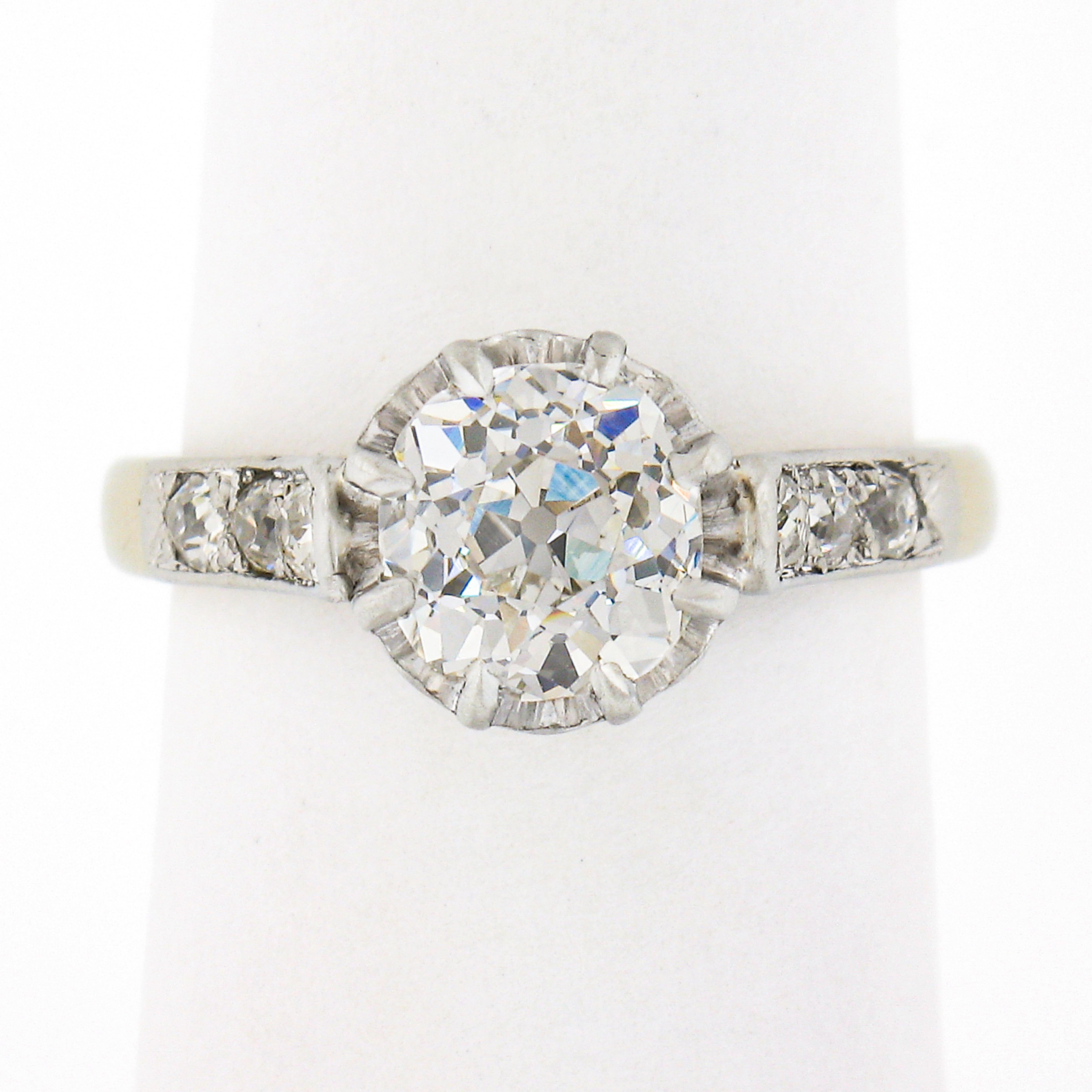 This breathtaking, all original, antique diamond engagement ring was crafted in France from solid 18k white gold and platinum during the Edwardian period. It features a gorgeous, GIA certified, old European cut diamond solitaire at its center