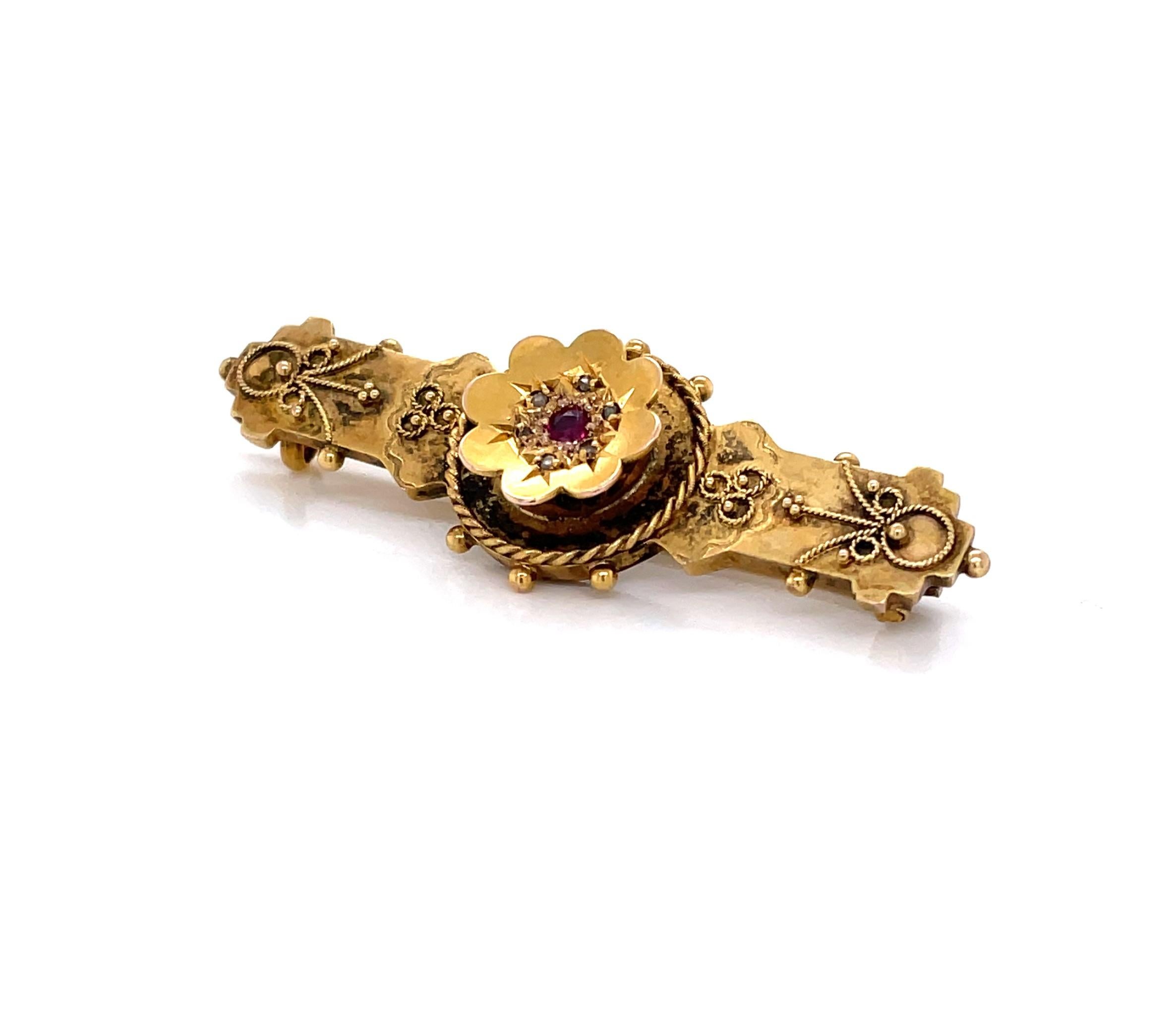Romantic antique accent piece, this petite Edwardian Gold Bar Pin has charming characteristics of the period. Of nine karat yellow gold with an antique patina, the pin measures 1-3/4 inches and is decorated with fine gold thread appliques with a