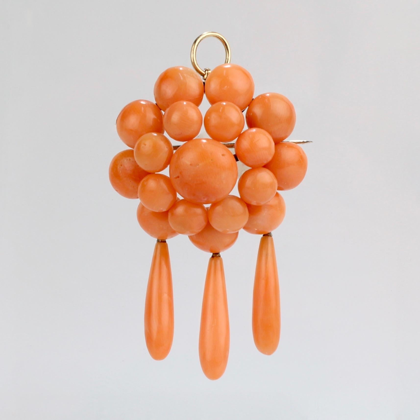 A fine Edwardian coral set comprised of a convertible chandelier pendant/brooch and a pair of chandelier dangle earrings.

Each piece set with multiple salmon-colored coral cabochons and each supporting 3 coral dangle drops. The brooch is fashioned