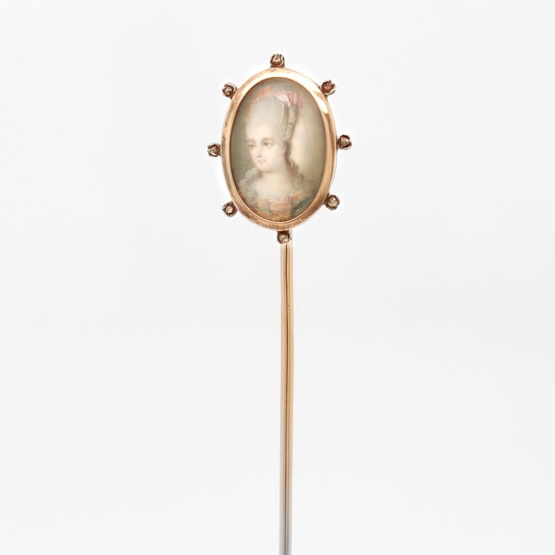 A fine antique Edwardian stickpin.

In antique high karat yellow gold with tiny rosecut diamonds.

With a portrait miniature under glass of a Rococo lady (not observed outside the setting).

Simply a wonderful stickpin!

Date:
Early 20th