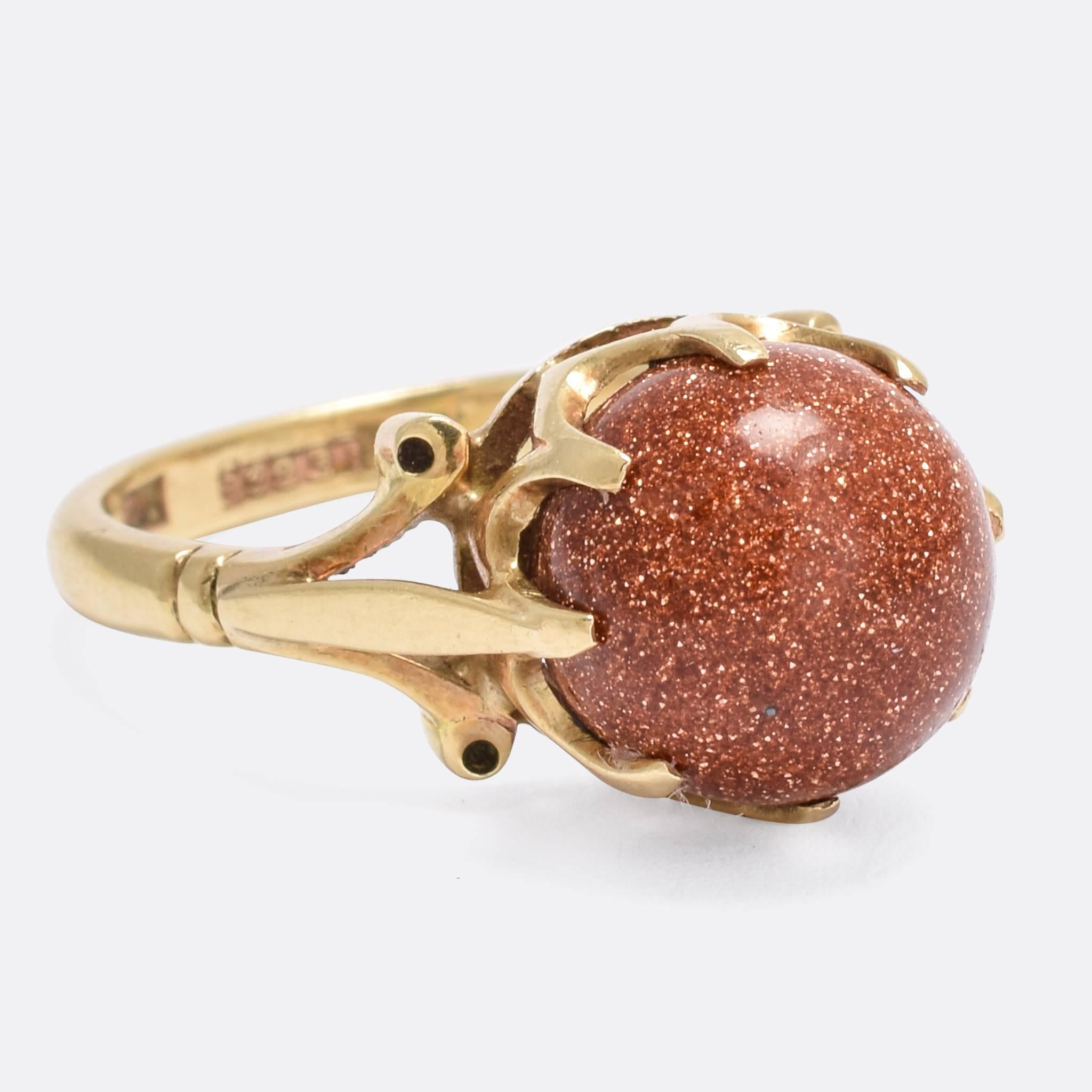 An unusual antique ring, set with a goldstone orb in exaggerated claw settings. It's finished with typically Edwardian flourishes, modelled in 9k yellow gold throughout. 

Goldstone, also known as aventurine glass or monkstone, is a kind of