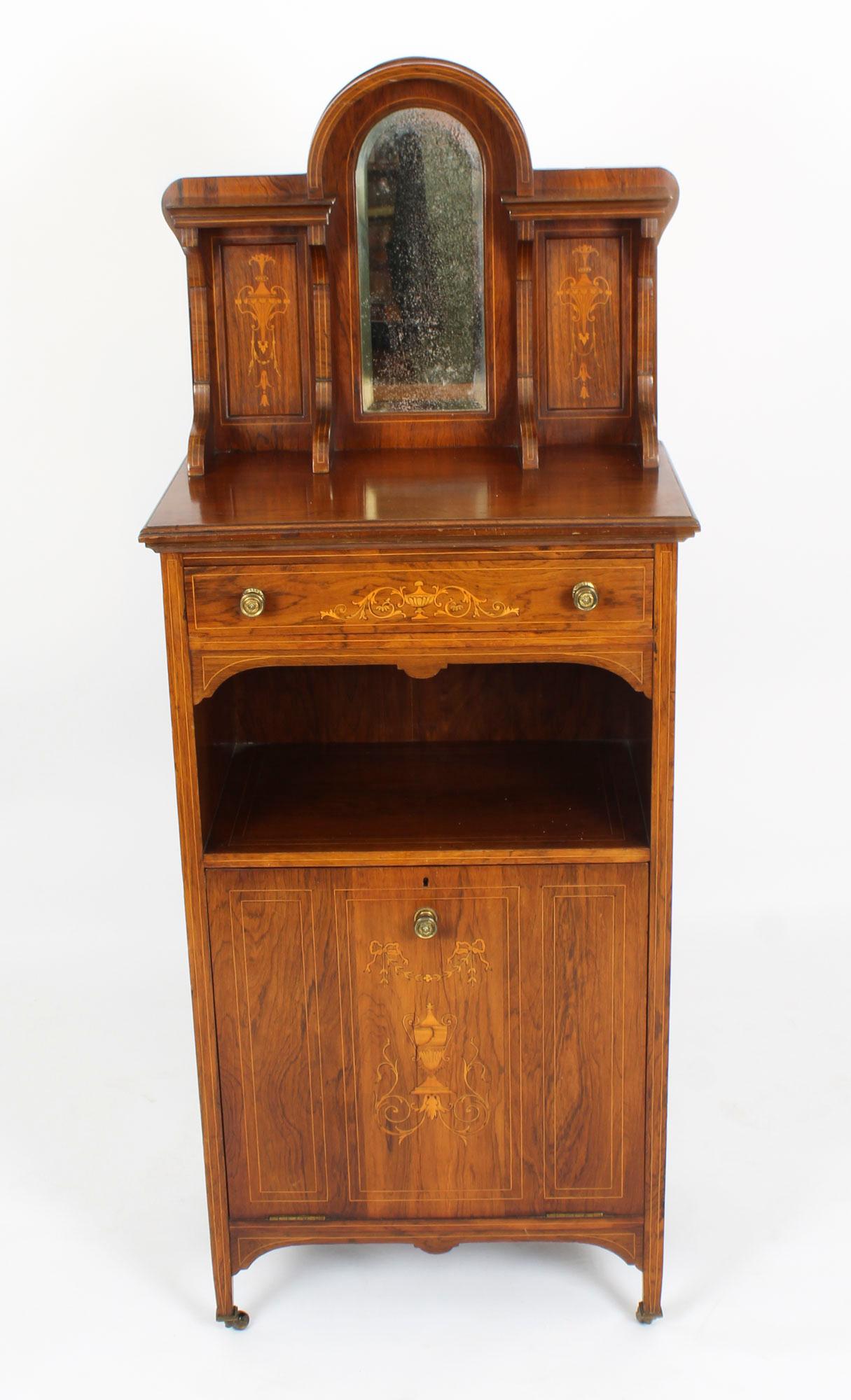 This is a beautiful antique Gonçalo alves and boxwood marquetry inlaid music cabinet, circa 1880 in date. 

The rectangular top has a mirrored marquetry gallery, above a single frieze drawer. The panelled cupboard door slides outwards and has