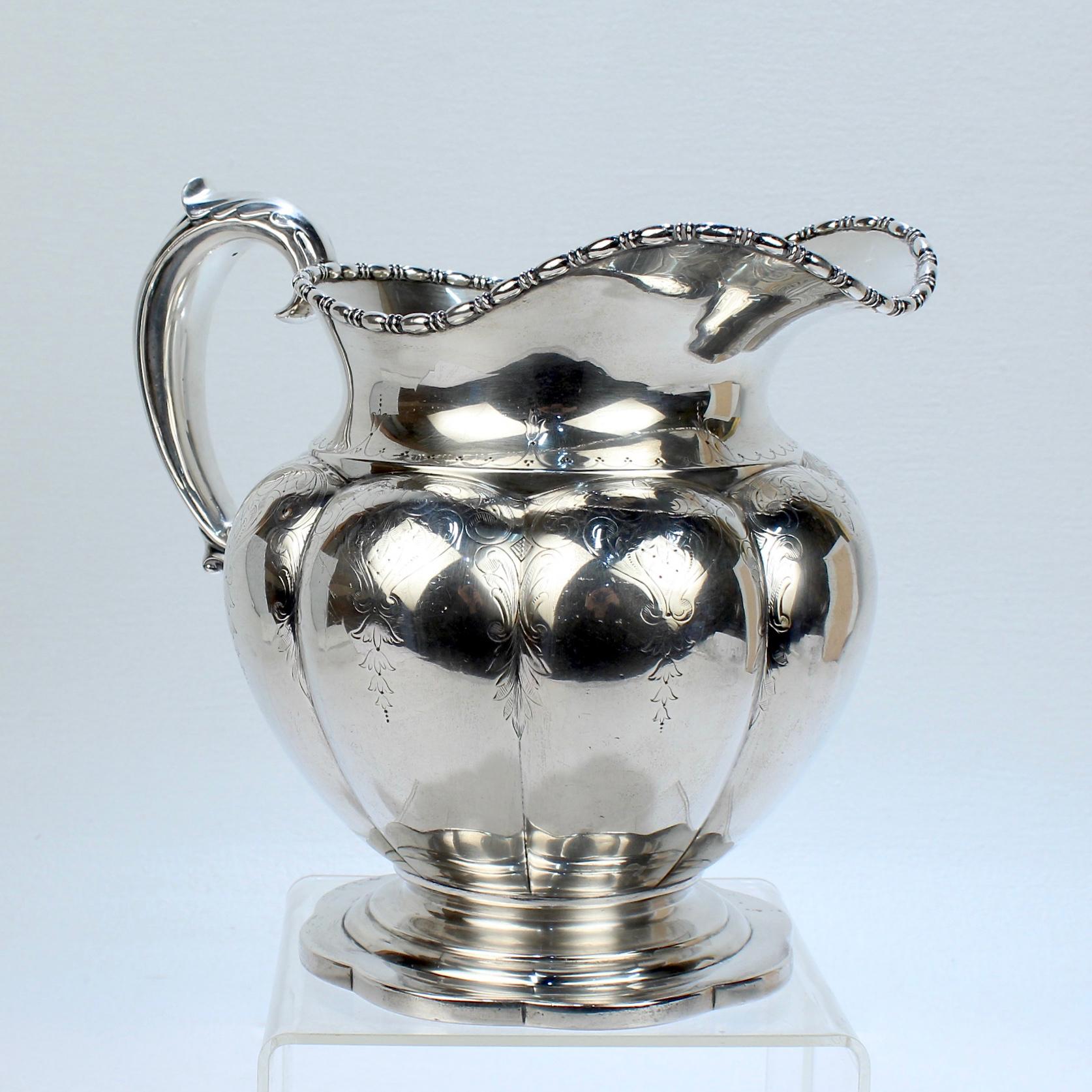 A wonderful antique American sterling silver water pitcher.

Made by Goodnow & Jenks of Boston and retailed by Bigelow, Kennard & Co.

The pitcher has an terrific lobed, vasi-form body, a gadrooned rim, a scalloped foot, and intricate engraved