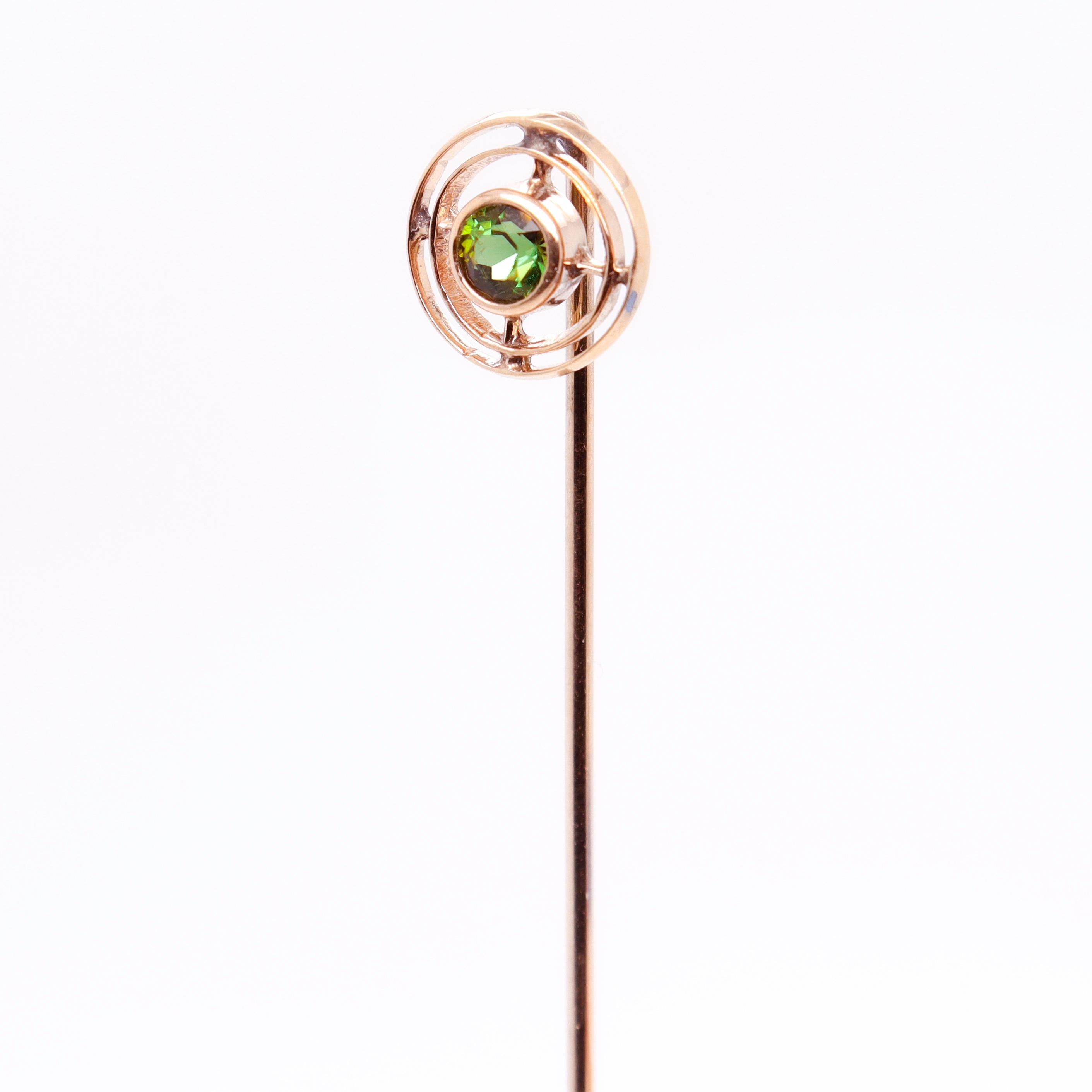 A very fine Edwardian tourmaline stickpin.

In 10k yellow gold.

With concentric gold circles surrounding a round faceted, bezel set green tourmaline gemstone.

Simply a great stickpin!

Date:
Early 20th Century

Overall Condition:
It is in overall