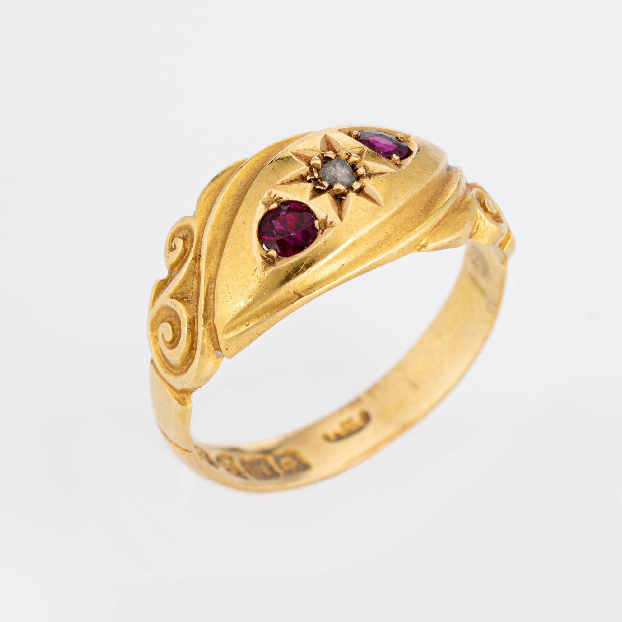 Elegant antique Edwardian era band (circa 1909) crafted in 18 karat yellow gold. 

Centrally mounted estimated 0.01 carat rose cut diamond is accented with two estimated 0.02 carat rubies. The diamond is estimated at L-M color and I3 clarity. 

The