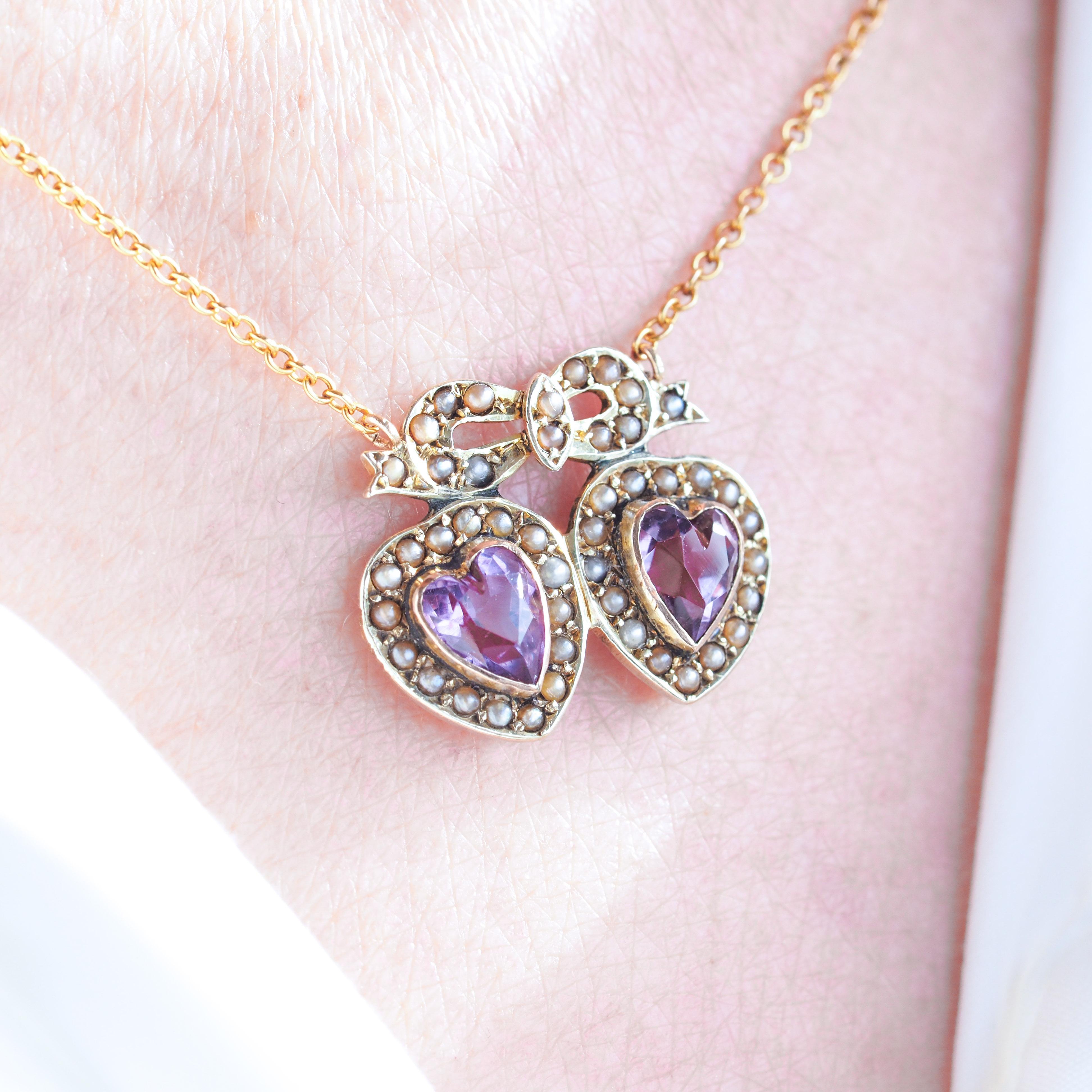 We are delighted to offer this lovely antique Edwardian 9ct gold amethyst and seed twin heart necklace made c.1910.

Intricate, delicate and elegant, this necklace presents a wonderfully romantic and feminine interlocked heart design.

The pendant