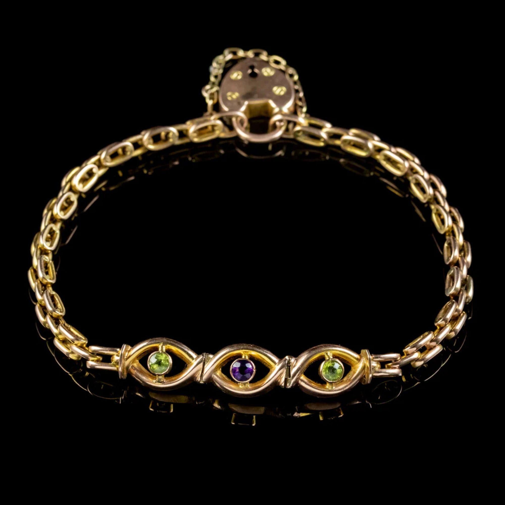 A beautiful Antique Edwardian bracelet from the early 20th Century made up of articulated 9ct Gold links which lead to a lovely open-worked gallery dotted with two Peridots and an Amethyst.

The piece is held by a 9ct heart padlock and safety chain