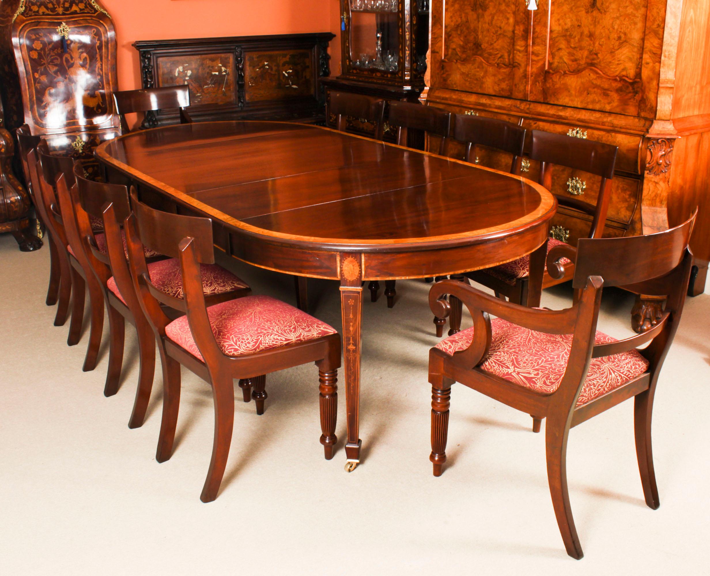 This is a fabulous antique Edwardian inlaid flame mahogany extending dining table, circa 1900 in date. 

The table has three original leaves and can comfortably seat ten. It has been hand-crafted from solid flame mahogany with a satinwood banded