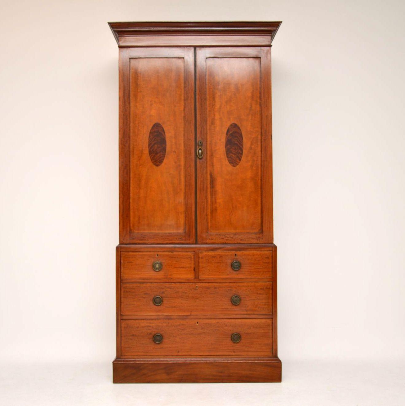 This antique Edwardian linen press has lovely slim proportions, which is a hard thing to find with these modals & is in excellent condition. It’s mahogany with some Fine satinwood inlays & other nice features. The two top doors have flame mahogany