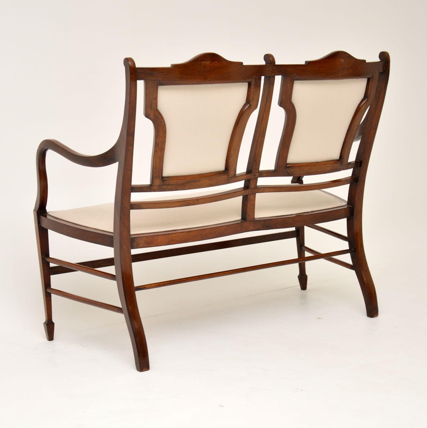 Very elegant antique Sheraton style mahogany settee dating from the 1890-1900 period and in good original condition. There are a few age related markings on the frame, but they have been polished out and everything is in character, plus it’s