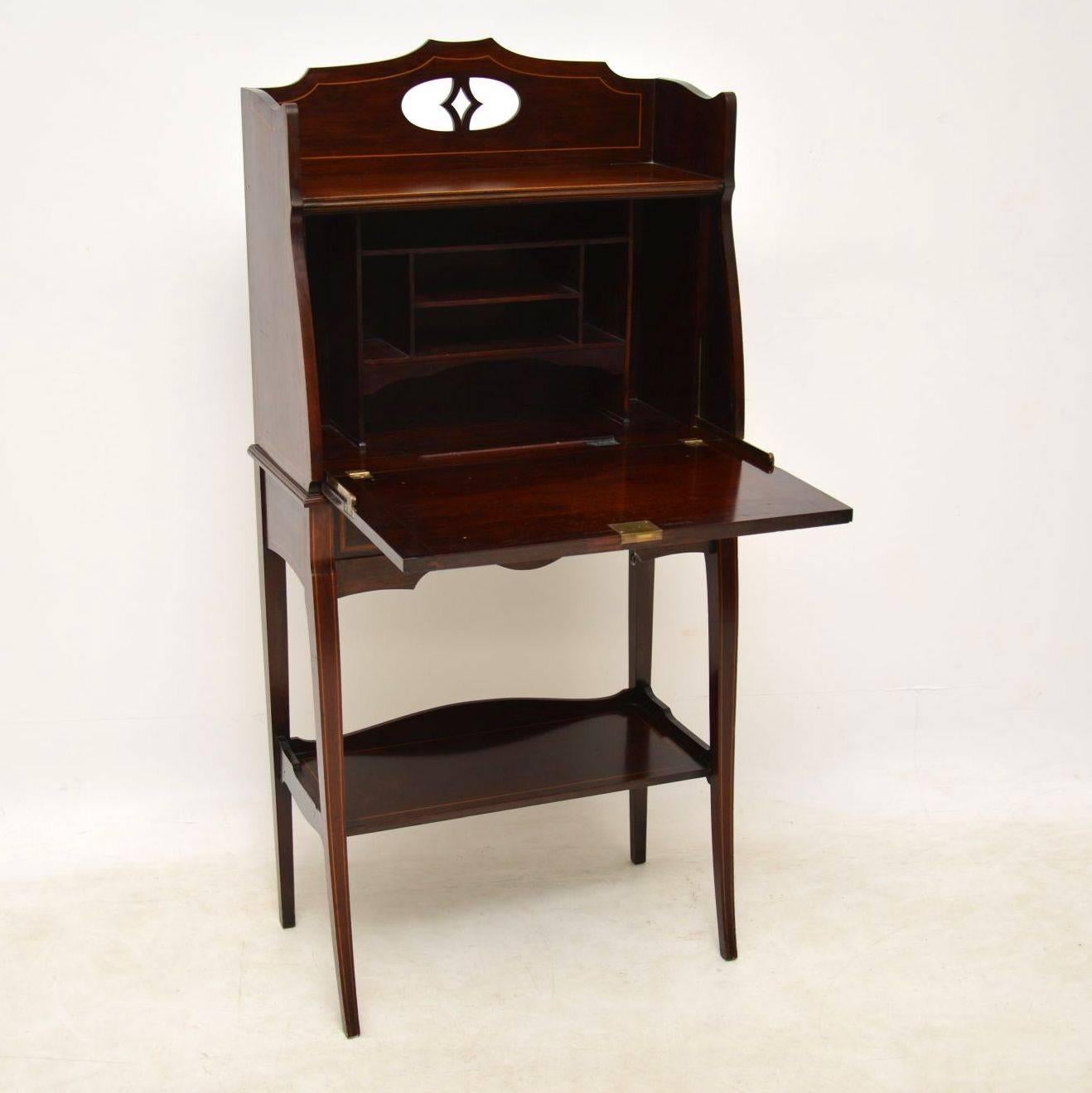 Very smart looking antique Edwardian mahogany bureau with fine inlays and other interesting features. This piece is also very useful if you're short of space, because it sits very flat against the wall. It's solid mahogany and of high quality