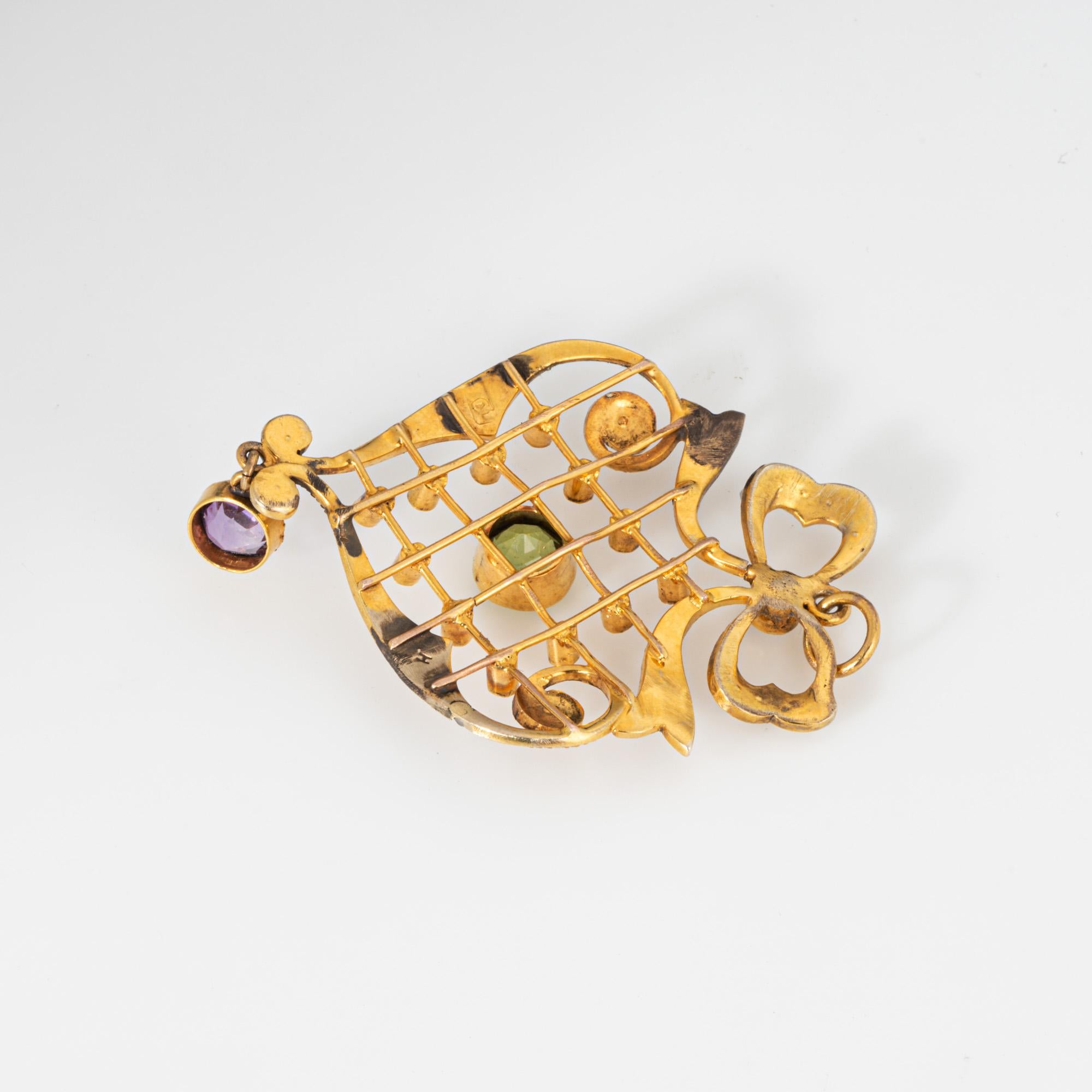 Finely detailed antique Edwardian lattice pendant (circa early 1900s), crafted in 9k yellow gold. 

Peridot measures 5mm. Amethyst measures 4.5mm. Small 1mm to 23mm seed pearls adorn the pendant.   

The beautifully detailed pendant highlights