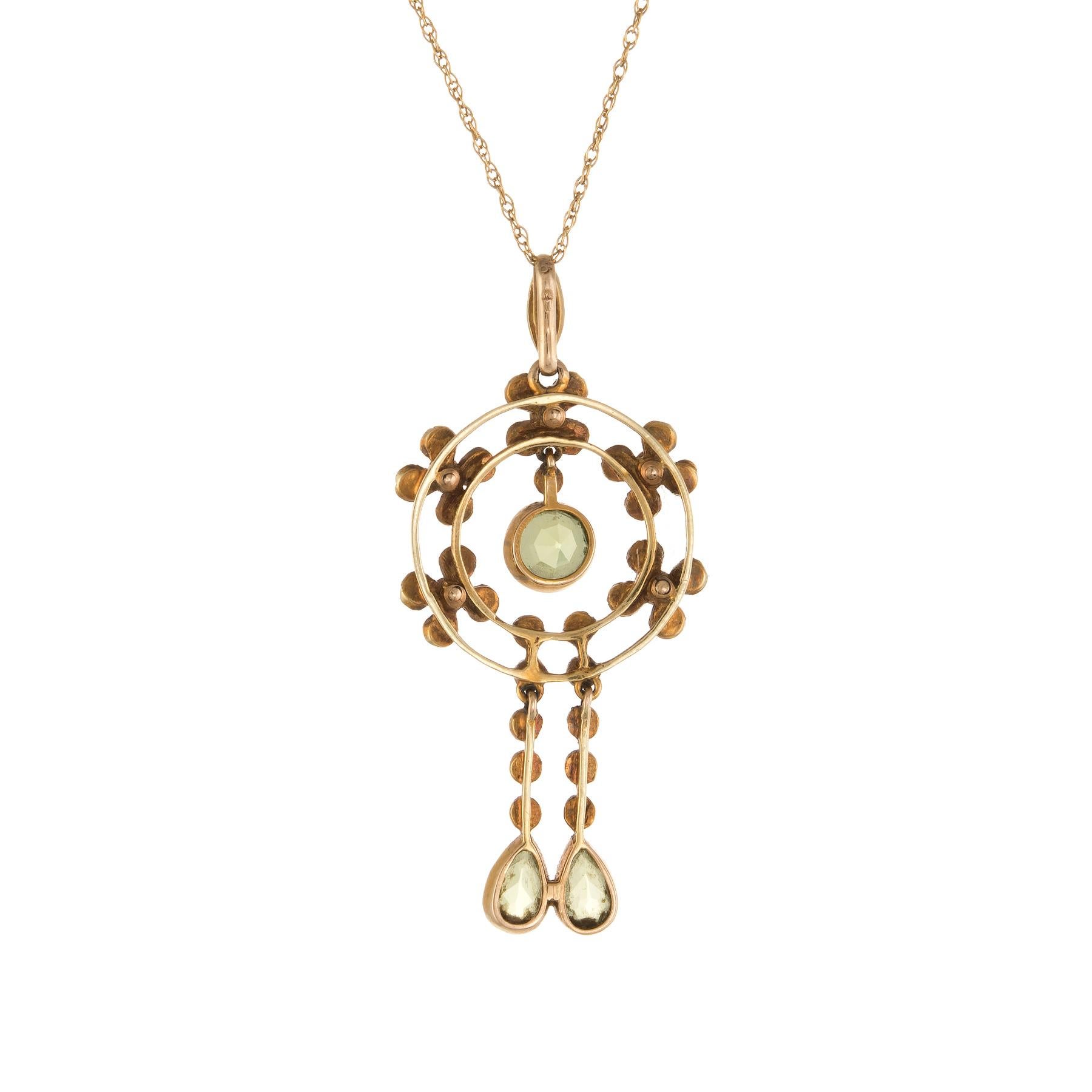 Finely detailed Edwardian era necklace (circa 1910s), crafted in 15 karat yellow gold with a 14 kart yellow gold chain.

Faceted round cut peridot (upper) is estimated at 0.60 carats, with two faceted pear cut peridot estimated at 0.50 carats each.