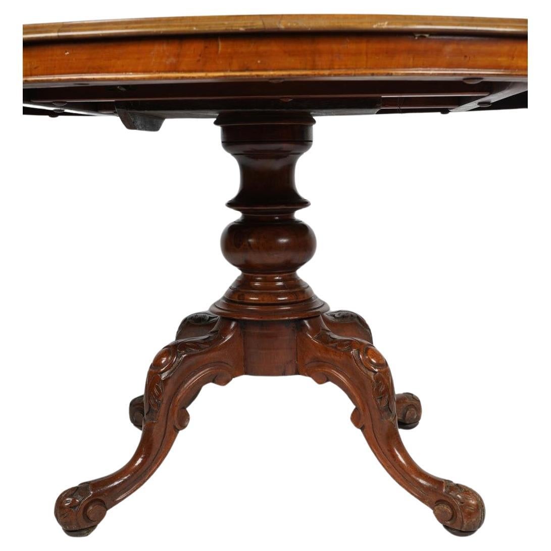 Age: 1850 - 1900

Furniture Style: Edwardian (1900 - 1910)

Overall Dimensions: 54 inches diameter; 29 1/2 inches high

Antique Late 19th C solid mahogany & burled walnut veneered dining table with tilt top; 

Note: This table top finish is slated