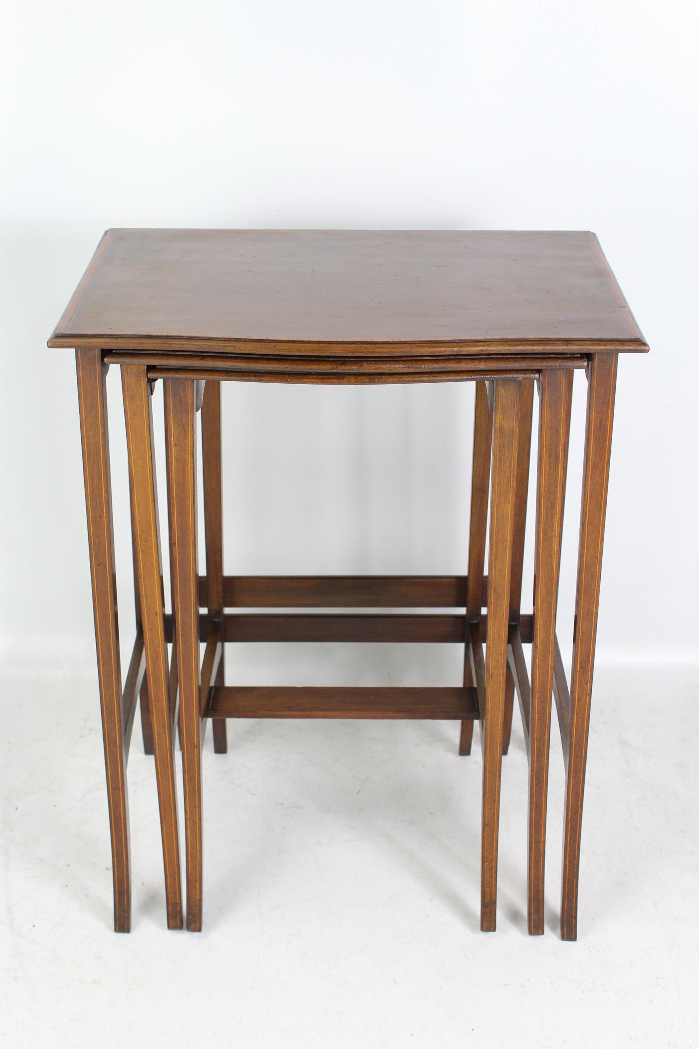 A charming antique Edwardian nest of 3 tables in mahogany with satinwood crossbanding dating from circa 1905. With rectangular tops, they stand on slender tapered legs with satinwood stringing. Solid and sturdy and in good condition.

