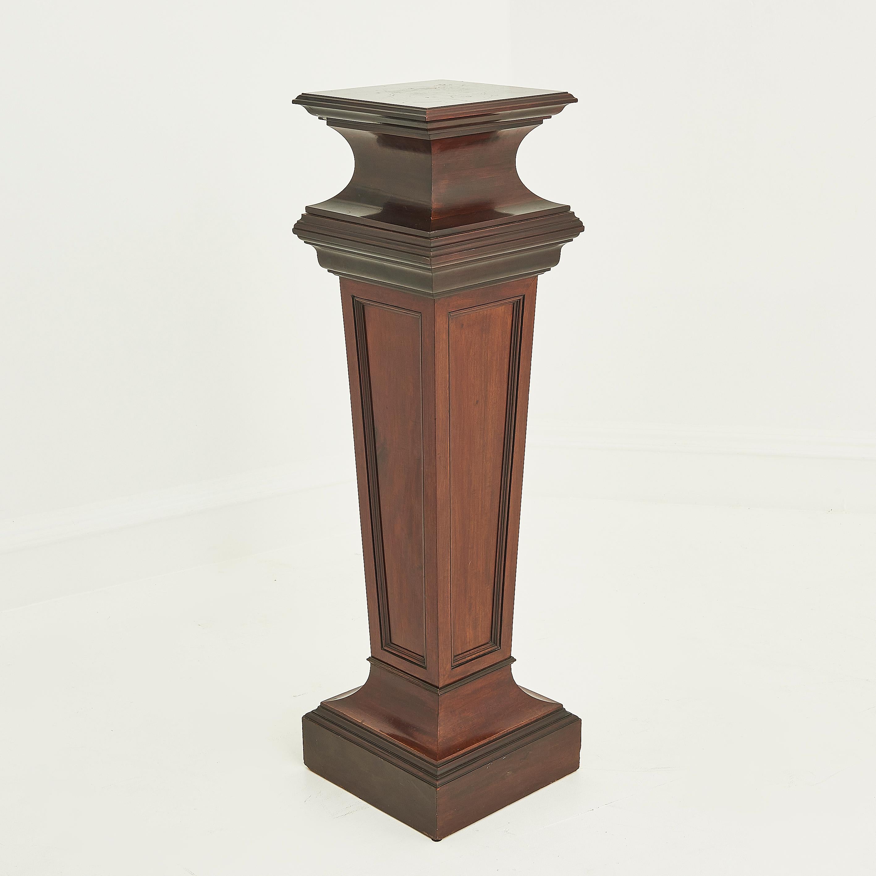 An antique Edwardian mahogany pedestal.

A beautiful example of the period’s craftsmanship, with its finely carved detailing and elegant proportions. 

This striking piece features a rich, warm patina that enhances the natural beauty of the mahogany