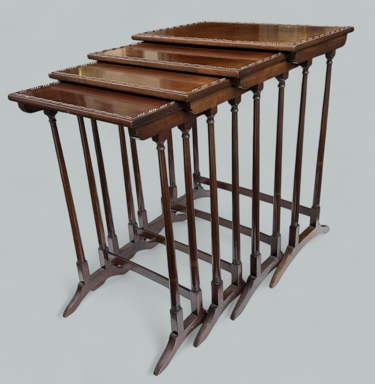 Superb Set of Edwardian polished Mahogany occasional Nest of Tables of English origin, circa 1900. 
Of traditional graduated size, these stacking or nesting tables with rectangular tops stylishly decorated with a border of lozenge and beaded