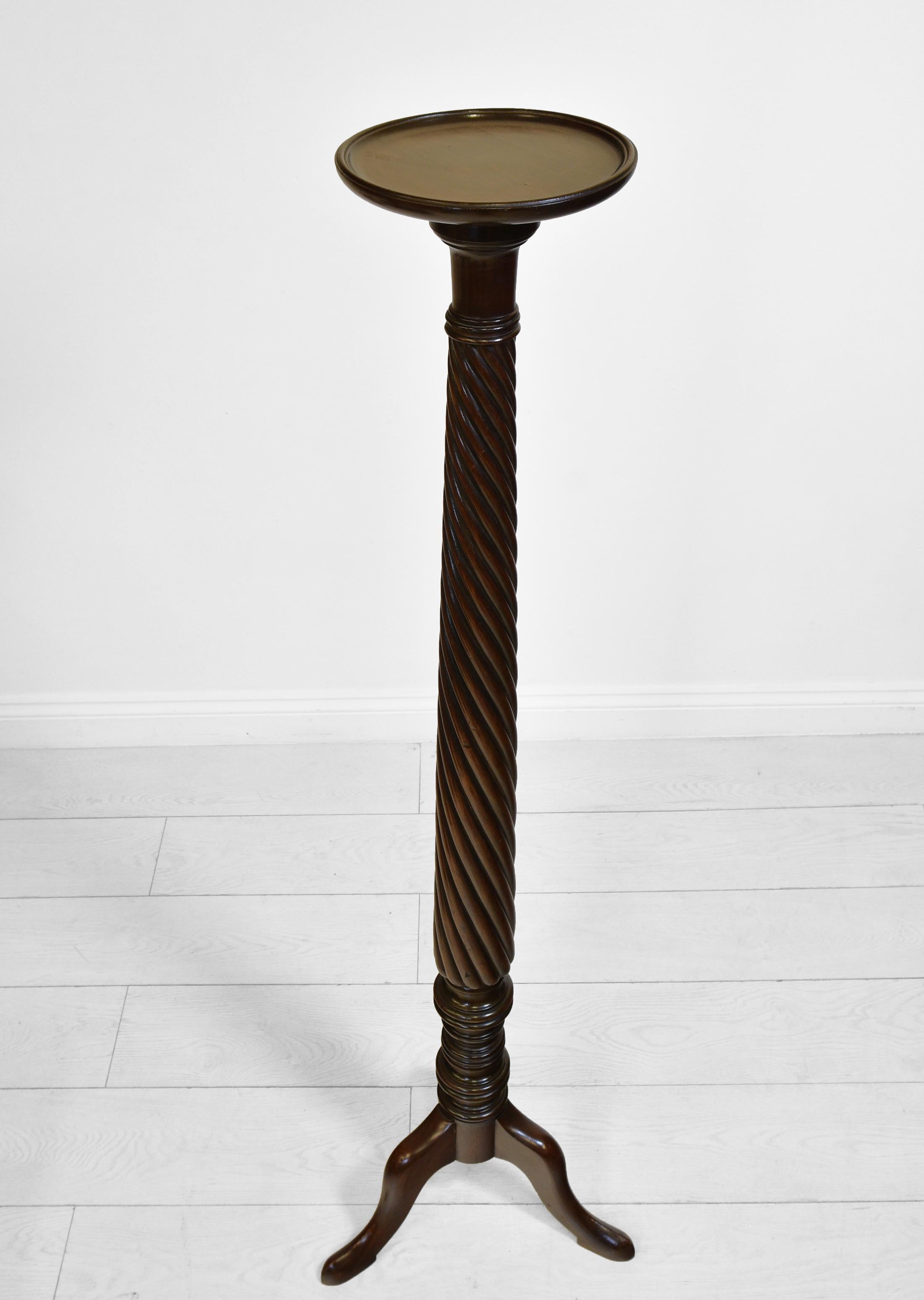 An early 20th century tall Honduran mahogany torchere with spiral turned support, and tripod legs. Circa 1910.

The torchere has been cleaned and waxed and it is in very good condition, structurally very solid with no loose joints or damage. There