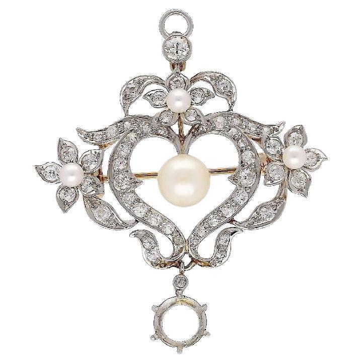 An original antique from the Edwardian era, circa 1910, featuring a natural pearl and a 1.69 carat European-cut diamond certified by the GIA. The delightful piece features 3 seed pearls along with a natural 8mm round pearl in its center. It is
