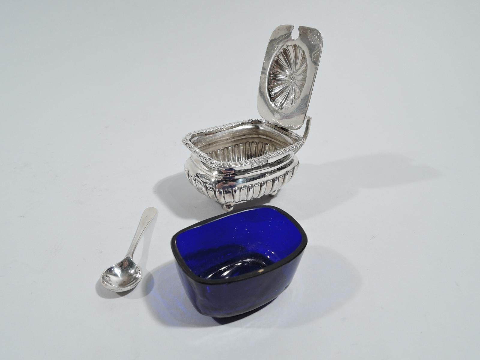 English Edwardian Neoclassical sterling silver mustard pot. Made by John & William Deakin in Chester in 1908. Rectilinear and bellied body with alternating gadroons and flutes on 4 ball supports. Reeded scroll bracket handle. Cover hinged with domed