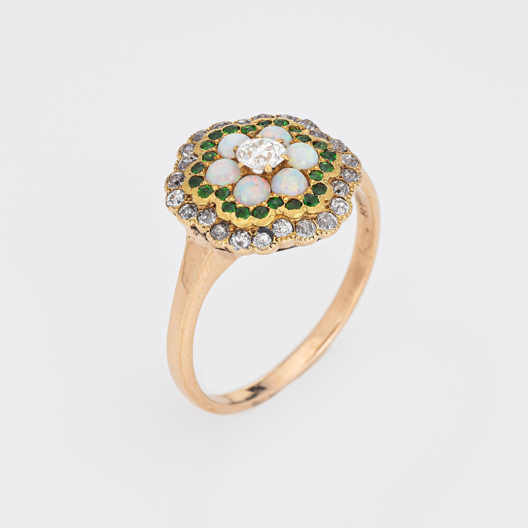 Finely detailed antique Edwardian opal, diamond & demantoid garnet cluster ring crafted in 18k white gold (circa 1910s to 1920s).  

One center set old mine cut diamond is estimated at 0.20 carats, accented with a further 24 estimated 0.02 carat old