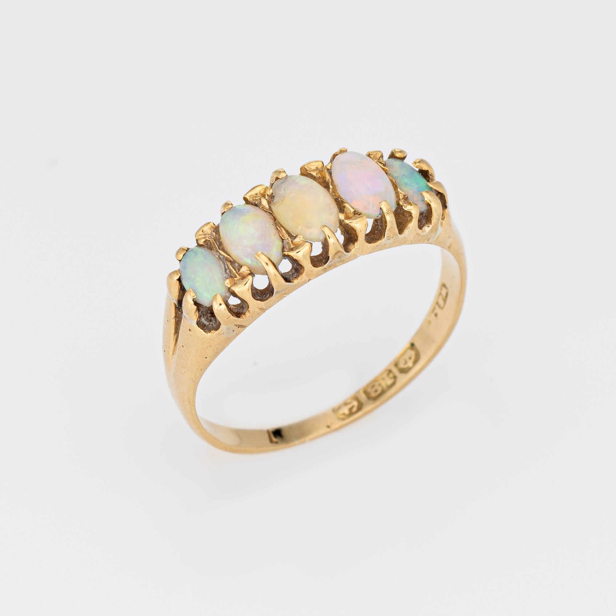 Antique Edwardian 5 stone opal ring (circa 1910s), crafted in 18 karat yellow gold. 

Five natural opals measure from 4mm x 3mm to 3mm x 2.5mm. The opals are in good condition with some wear evident (chip to one opal). 

The opals are set in a