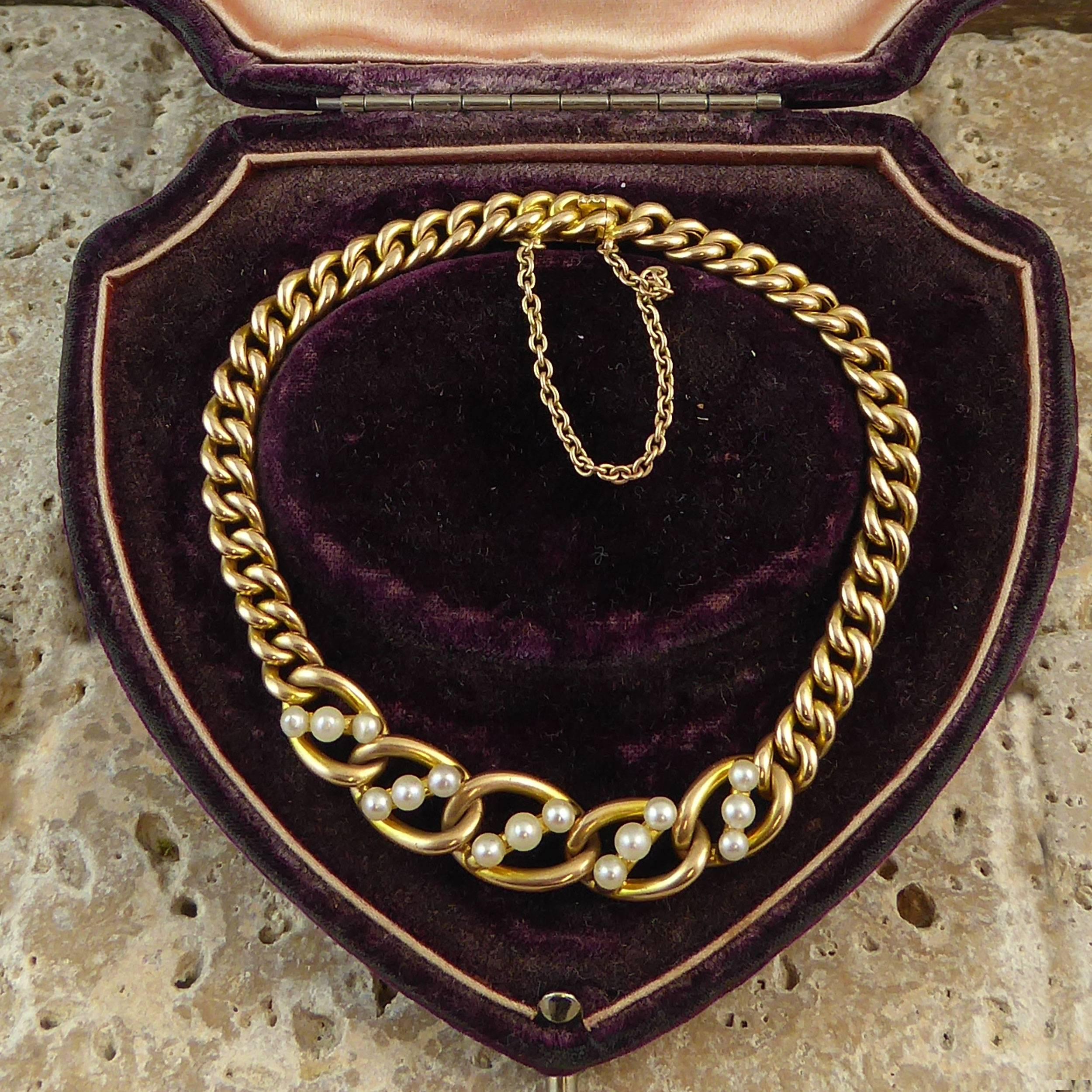 From the Edwardian era a gold curb link bracelet set to the centre with a section, approximately 2 inches long, of five elongated gold links each set with a row of three pearls set at an angle across the link.  The centre link measures approximately