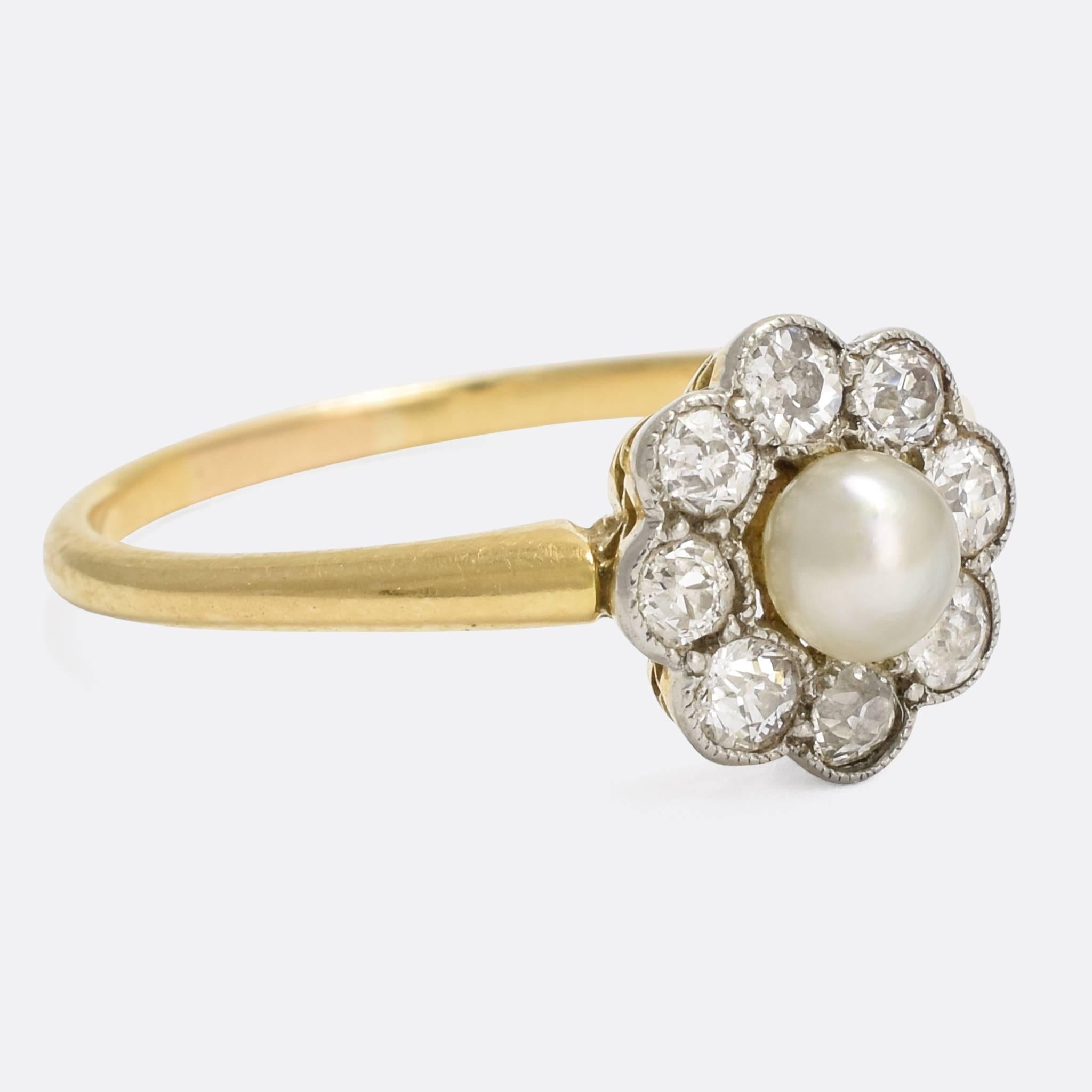 A pretty antique flower ring, set with eight old Euro diamonds arranged around a central pearl. The stones rest in platinum settings finished in fine millegrain detailing, while the slim band is crafted from 15 karat gold. A sweet ring in timeless