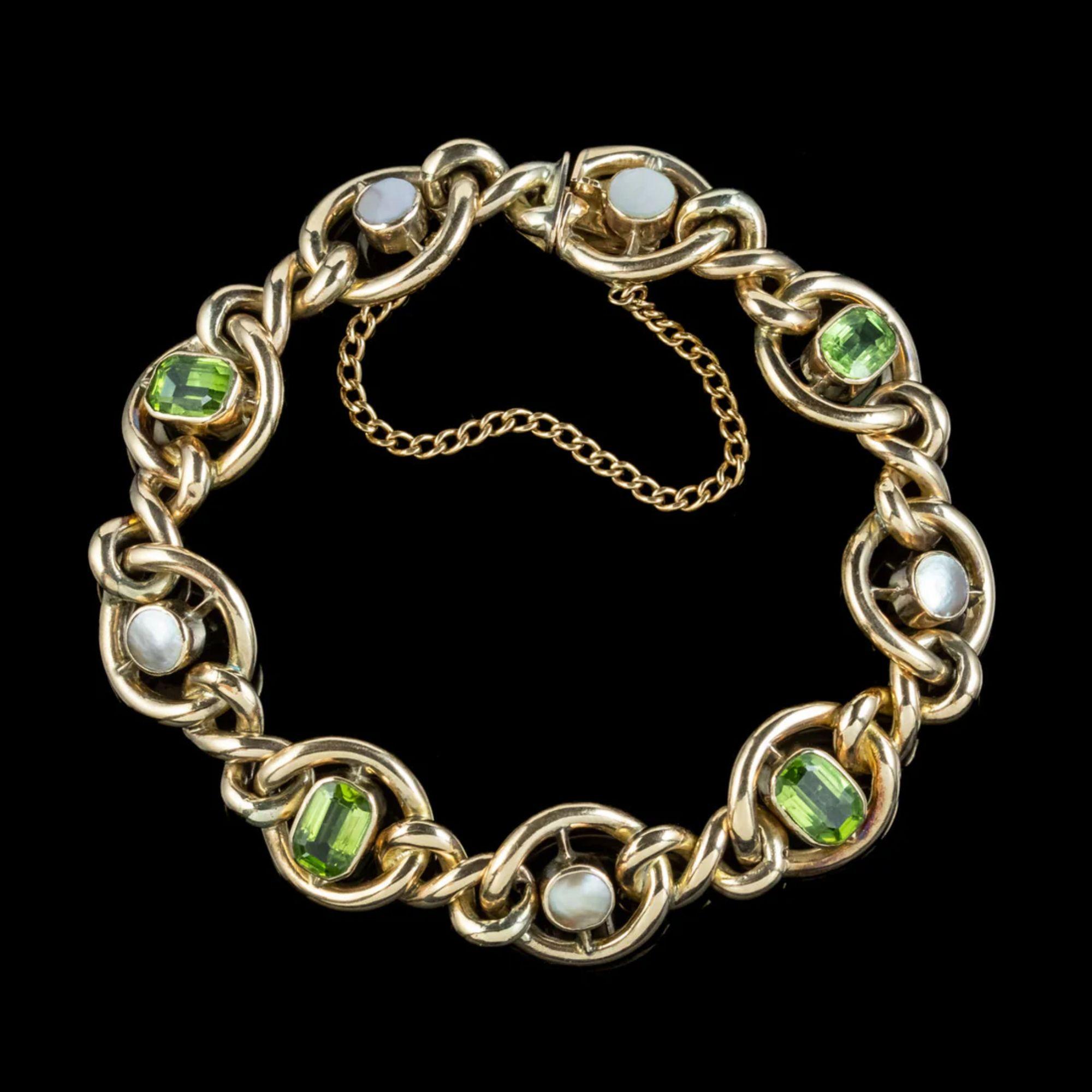 An attractive antique Edwardian curb bracelet fashioned in solid 9ct gold with four emerald cut peridots and four iridescent mabe pearls bezel set in the centre of each of the larger links.

Peridots are seen as a stone of springtime, a gift from