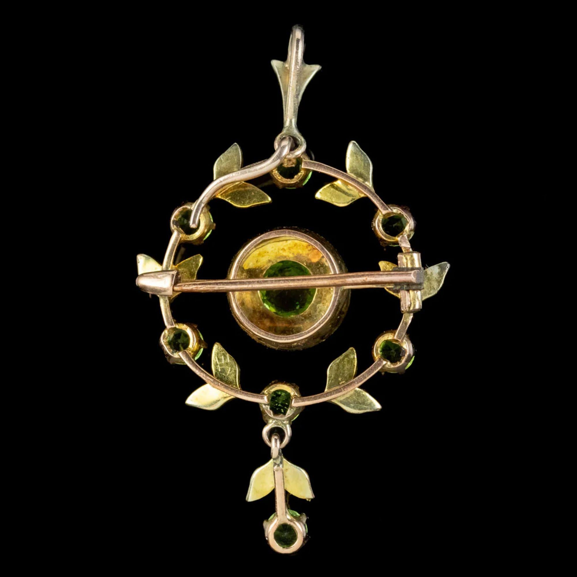 A fabulous antique Edwardian pendant from the early 20th Century adorned with a rich green old European cut peridot in the centre, haloed by bright pearls and a leafy wreath of additional pearls and peridots around the outside and down the dropper.