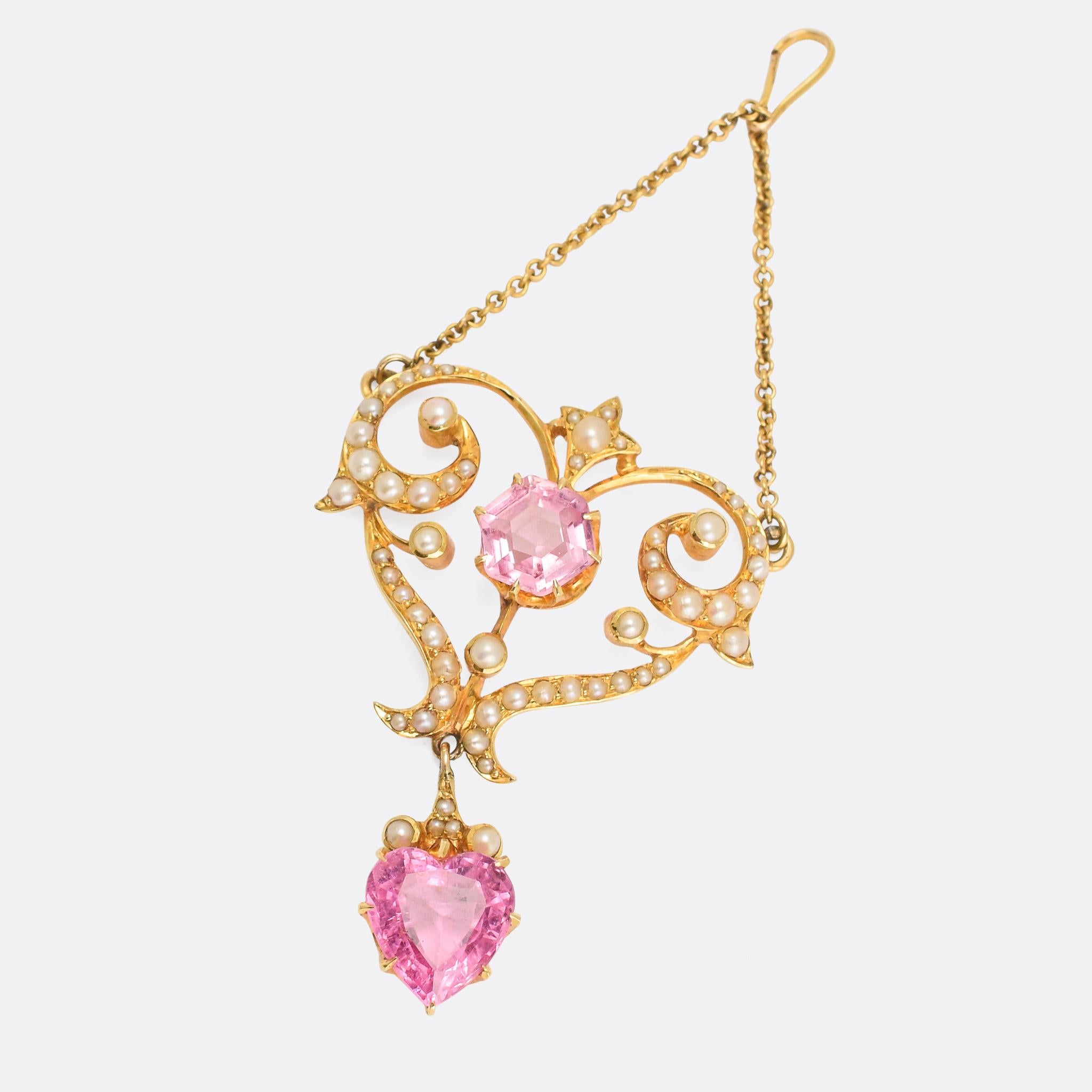 A beautiful antique lavaliere pendant set with pink tourmaline - octagonal and heart shaped - and seed pearls. The goldwork is exceptional, with flowing curves and graceful embellishments. It dates from the early 20th Century, circa 1905, and