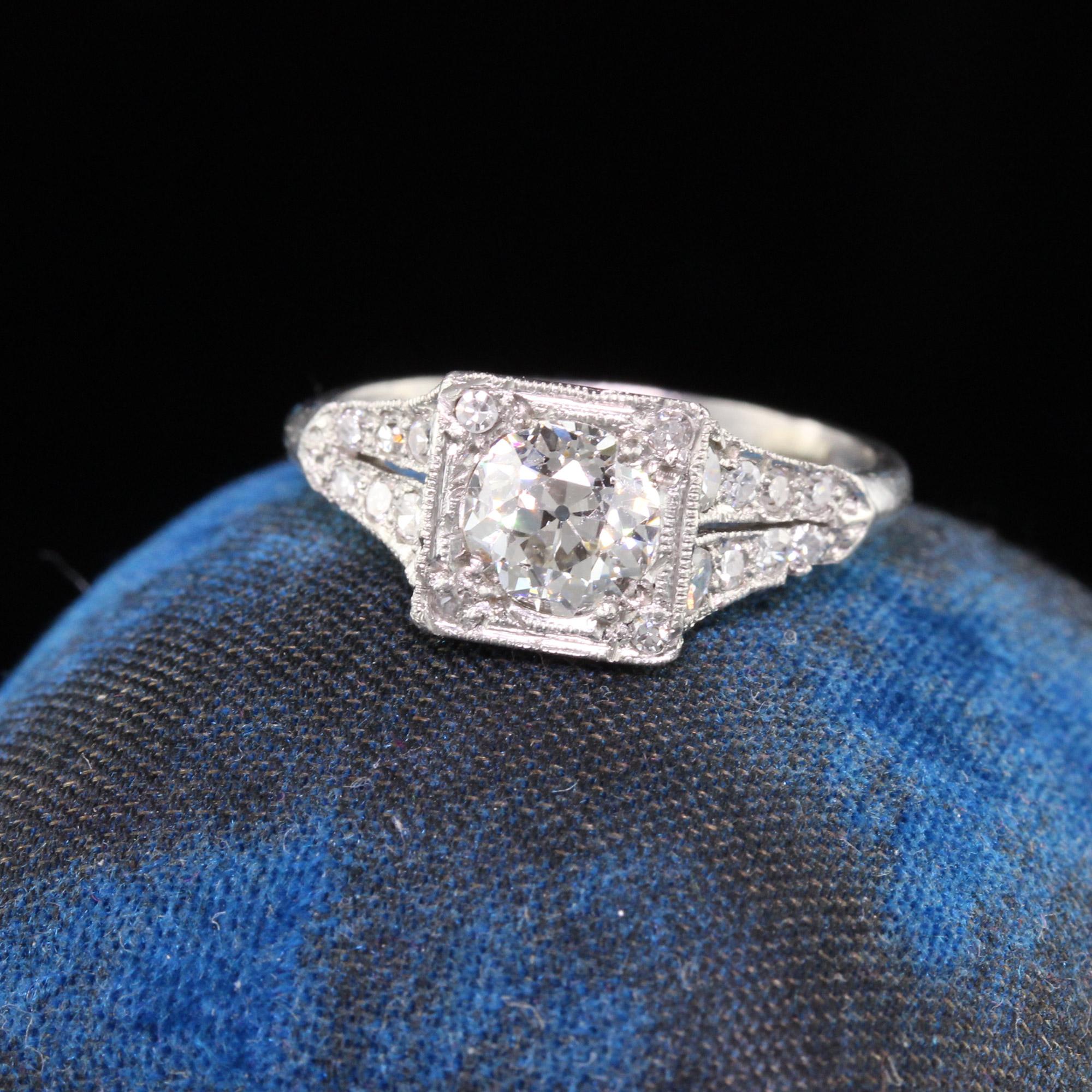 Beautiful Edwardian engagement ring in platinum featuring a 0.80 ct GIA certified old european cut diamond in the center and smaller diamonds going down either side with stunning engraving work on the profile. In very good condition.