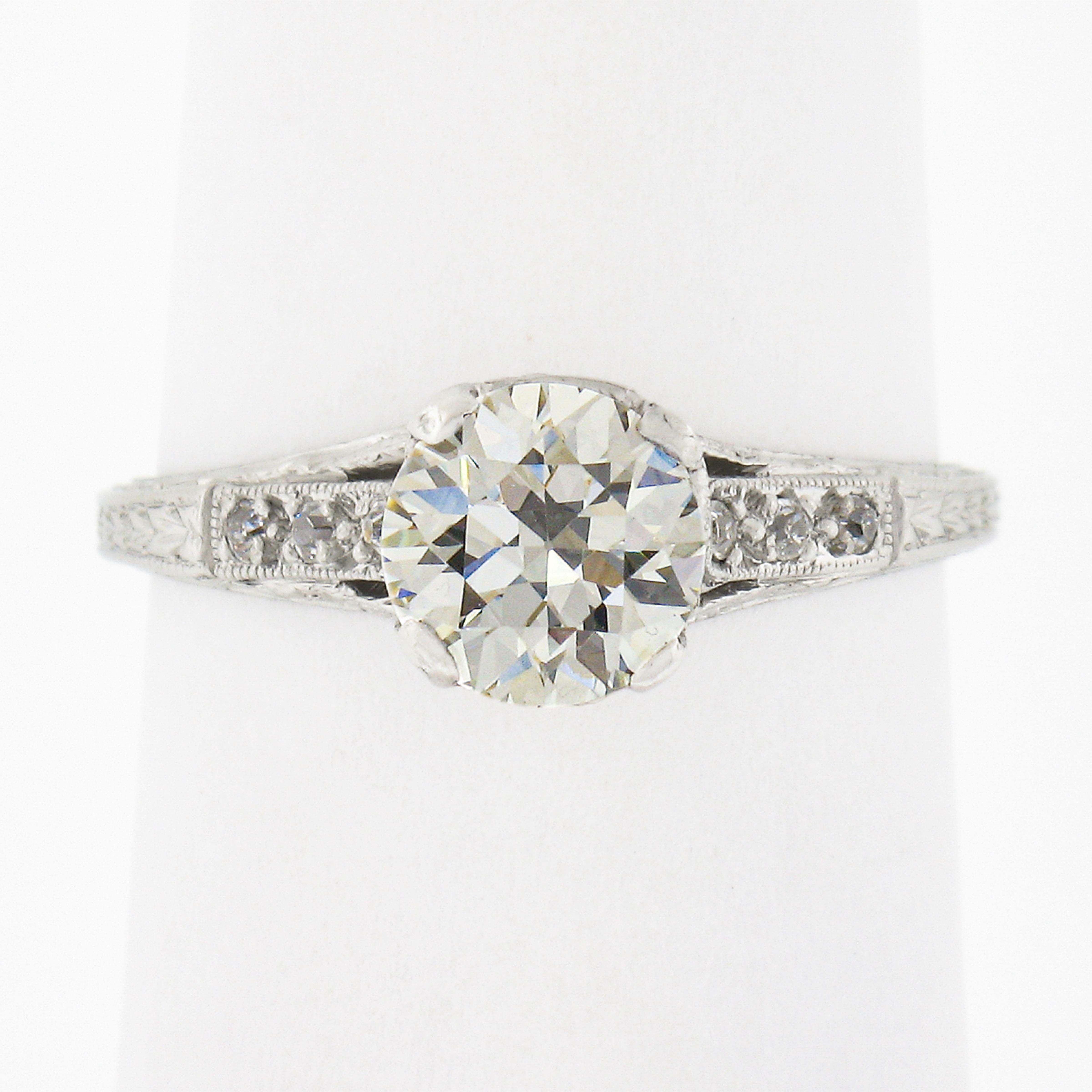 This is a gorgeous antique engagement ring that was crafted from solid platinum during the Edwardian period. It features a stunning old European cut diamond solitaire neatly set at the center, and displays a very attractive size, weighing