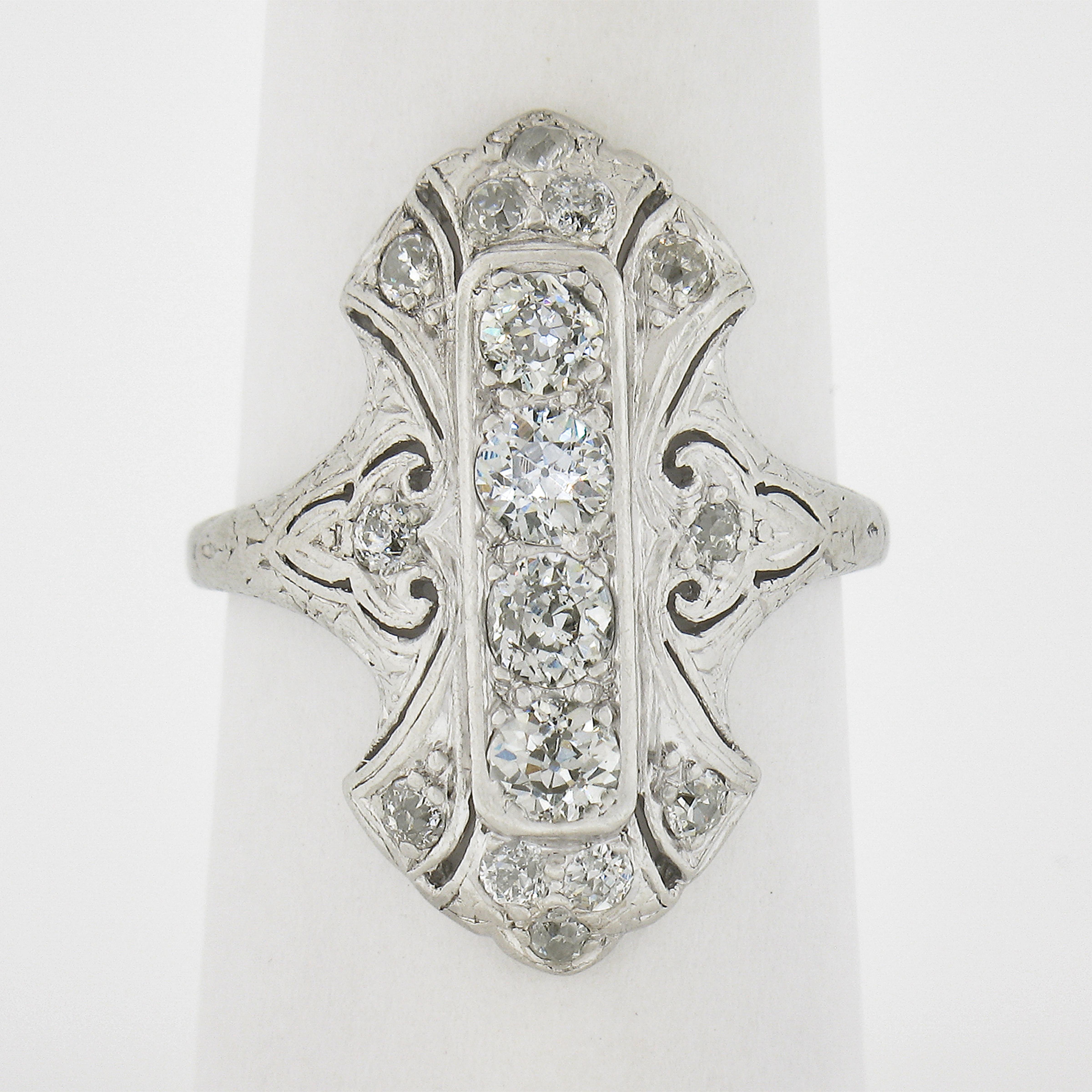 This incredible, all original, antique Edwardian period ring by Lambert Bros. is crafted in solid platinum. The ring showcases 16 old European & single cut diamonds elegantly pave set across the long and unusual design. The fiery diamonds in this