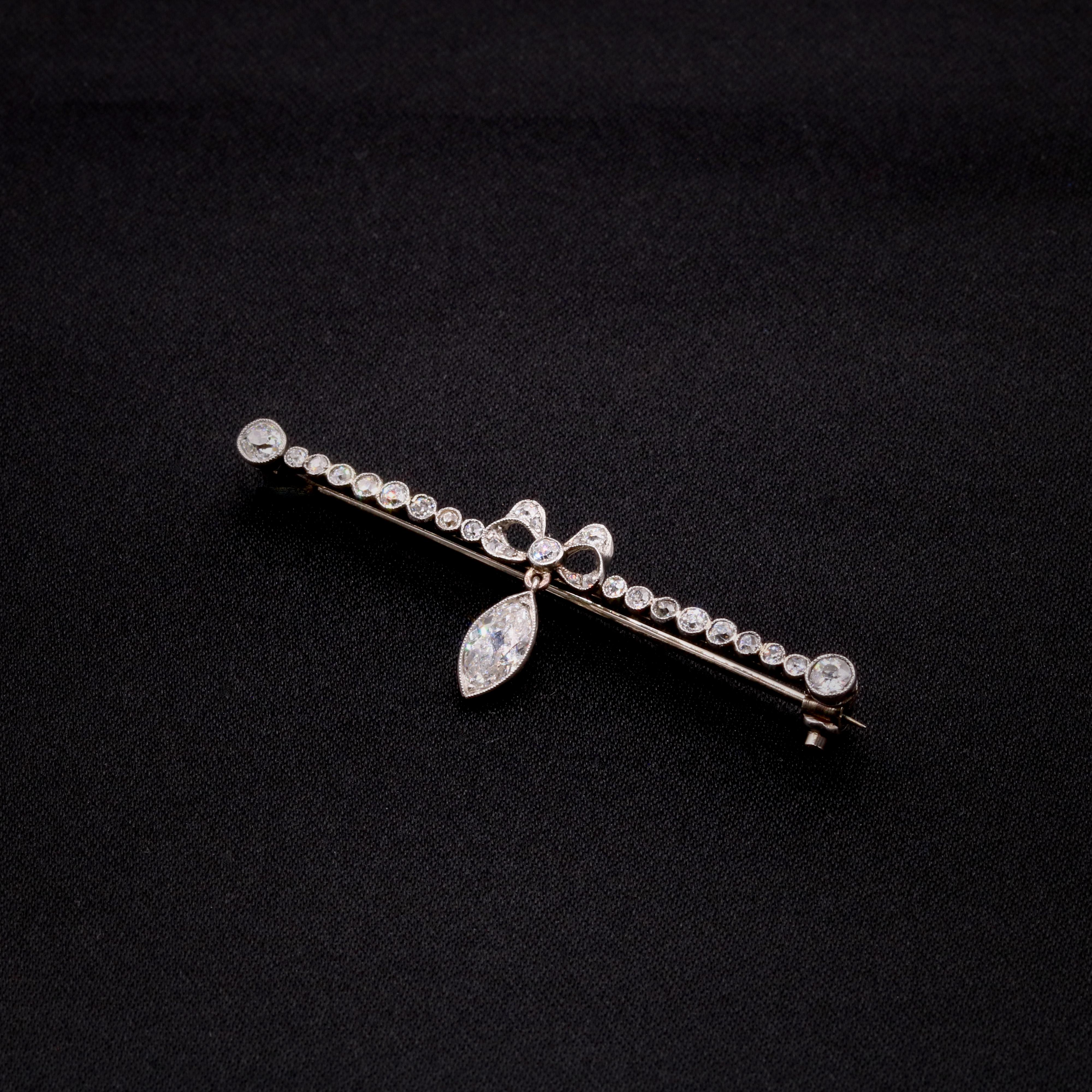 Women's or Men's Antique Edwardian Platinum and White Gold 1.18ctw Marquise Diamond Bow Brooch For Sale