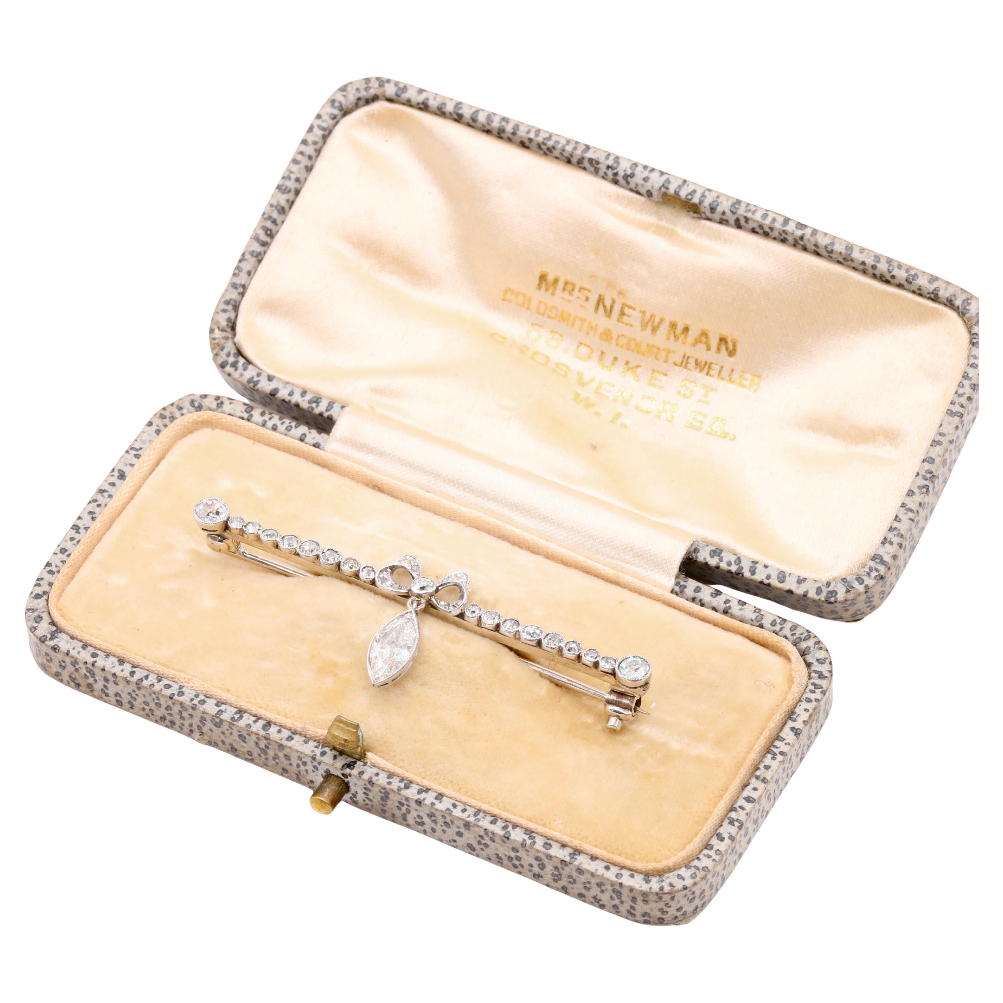 Antique Edwardian Platinum and White Gold 1.18ctw Marquise Diamond Bow Brooch For Sale
