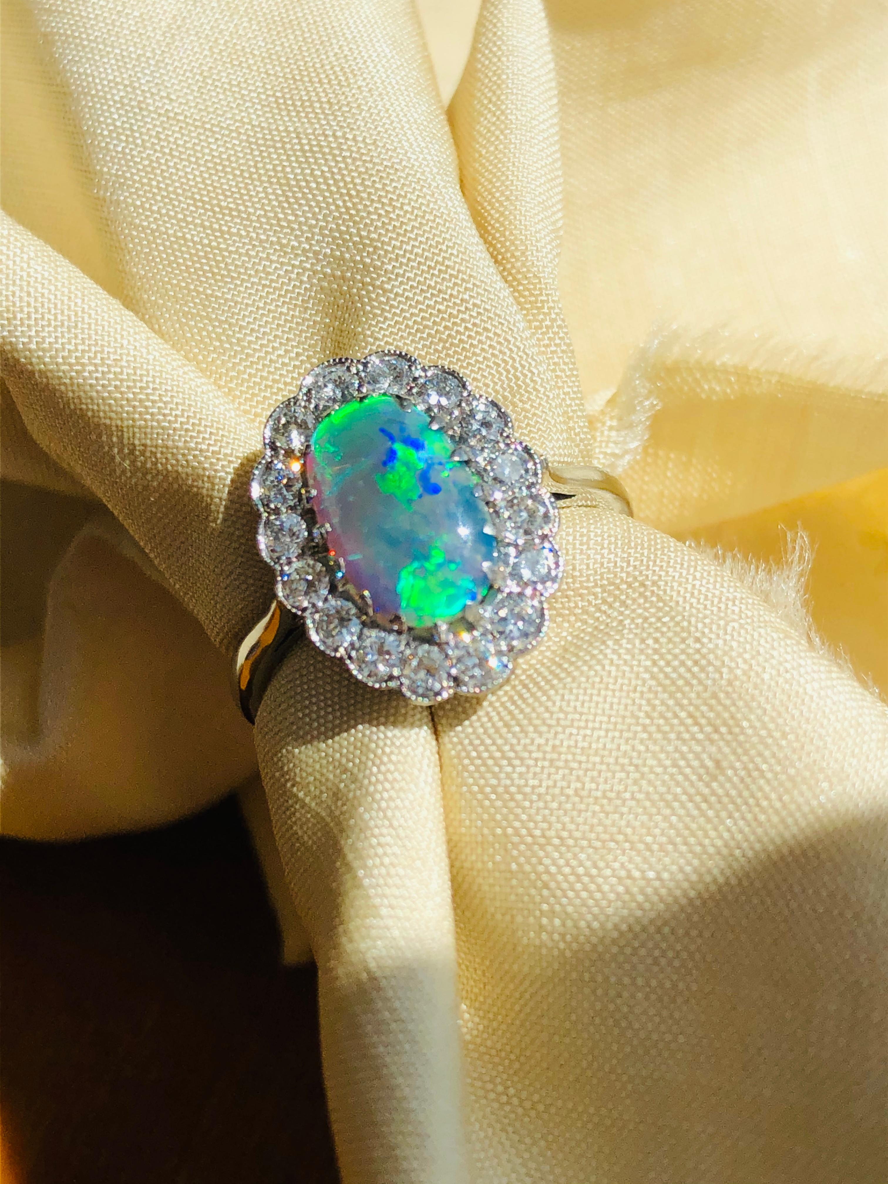 Art Deco, black opal and diamond ring, circa 1920. Set with an incredible black opal; displaying a strong mixture of green and blue tones surrounded by a single row of diamonds all set in platinum.

Black Opal: 10.5mm x 6.5mm x 3.5mm

Country of