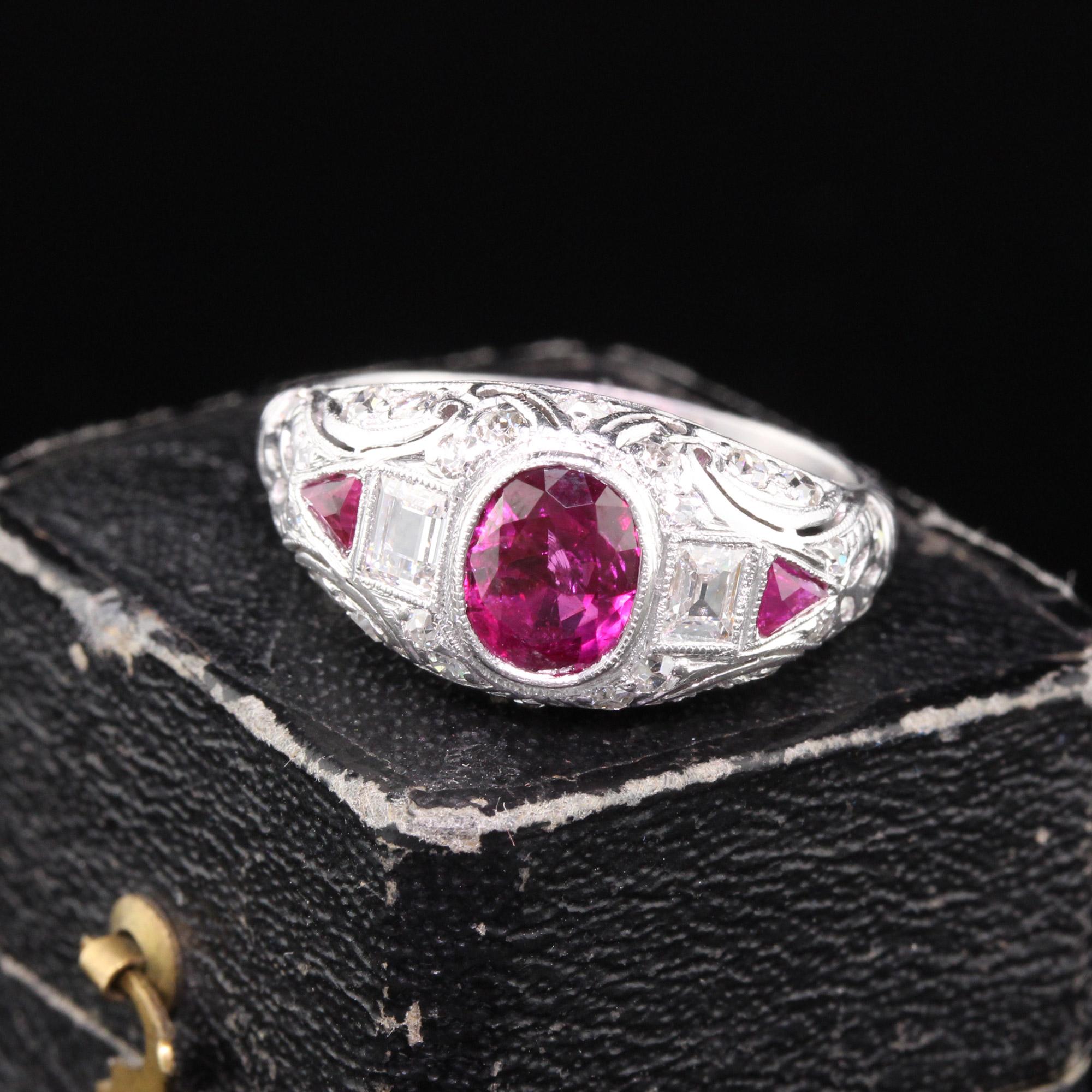Magnificent Edwardian ring featuring a GIA certified Burma no heat ruby in the center surrounded by two rectangular carre cut diamonds and trillion cut burma rubies in a pristine platinum diamond mounting. A work of art in excellent