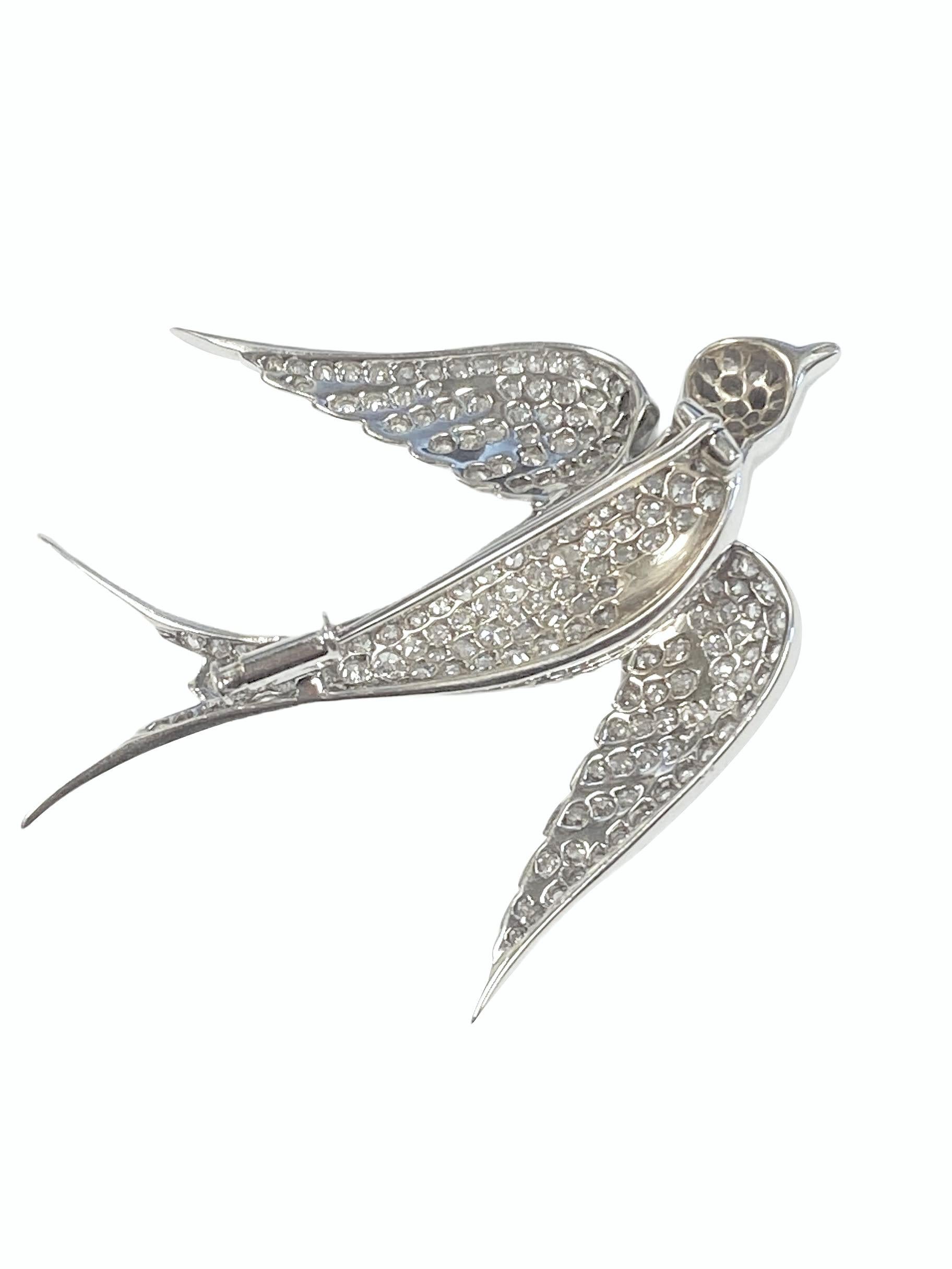 Circa 1920 Platinum Swallow Bird Brooch, measuring 2 1/2 inches in length and 2 inches from Wing tip to Tip. Set with White Clean old mine cut Diamonds totaling 5 Carats and further set with a Ruby in the Eye. Finely detailed and in excellent seldom