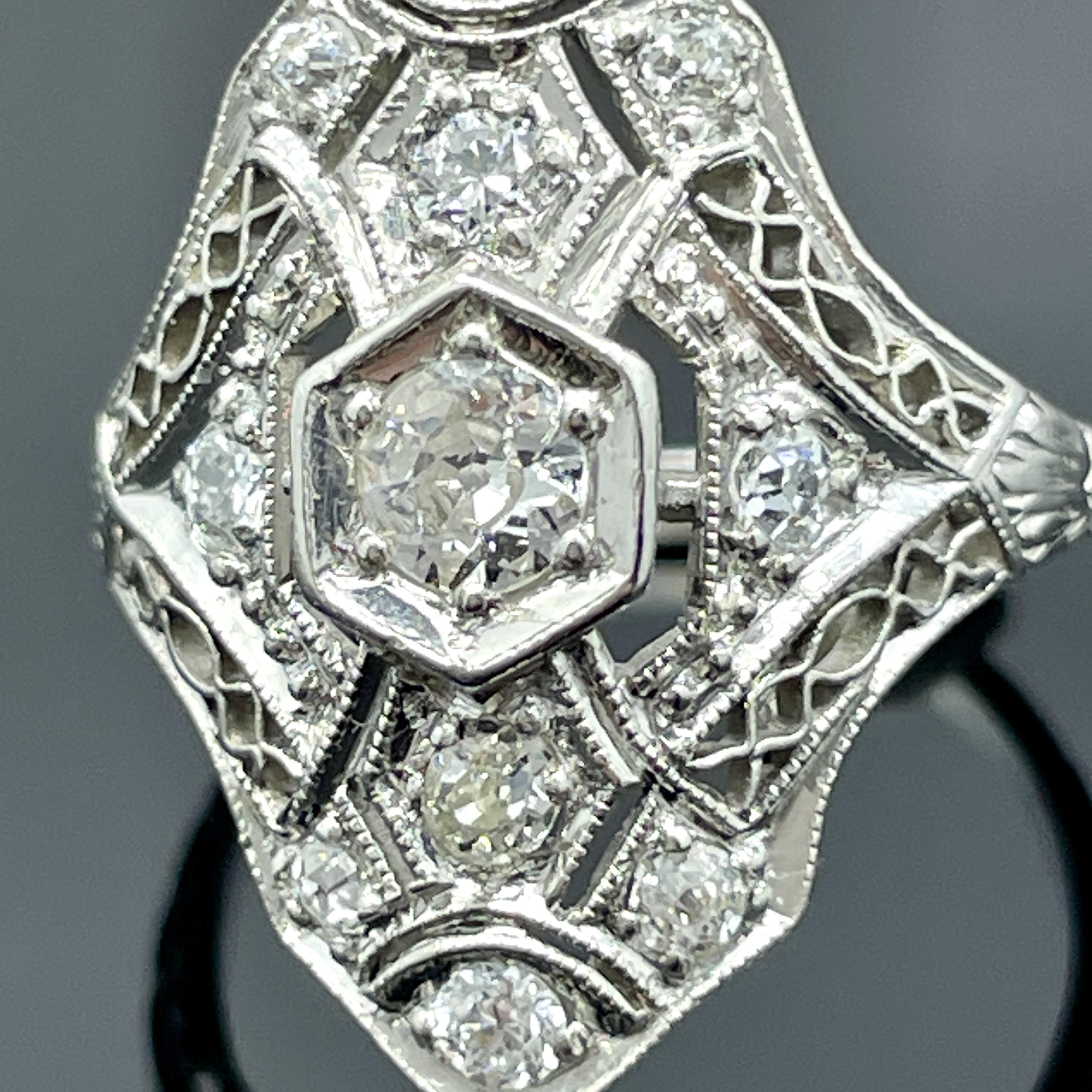 Antique Edwardian Platinum Filigree Diamond Ring – 0.50ctw, Size 3.5

A delicate masterpiece from the Edwardian era, this antique platinum ring showcases the intricate artistry and refined elegance of early 20th century jewelry. Set with